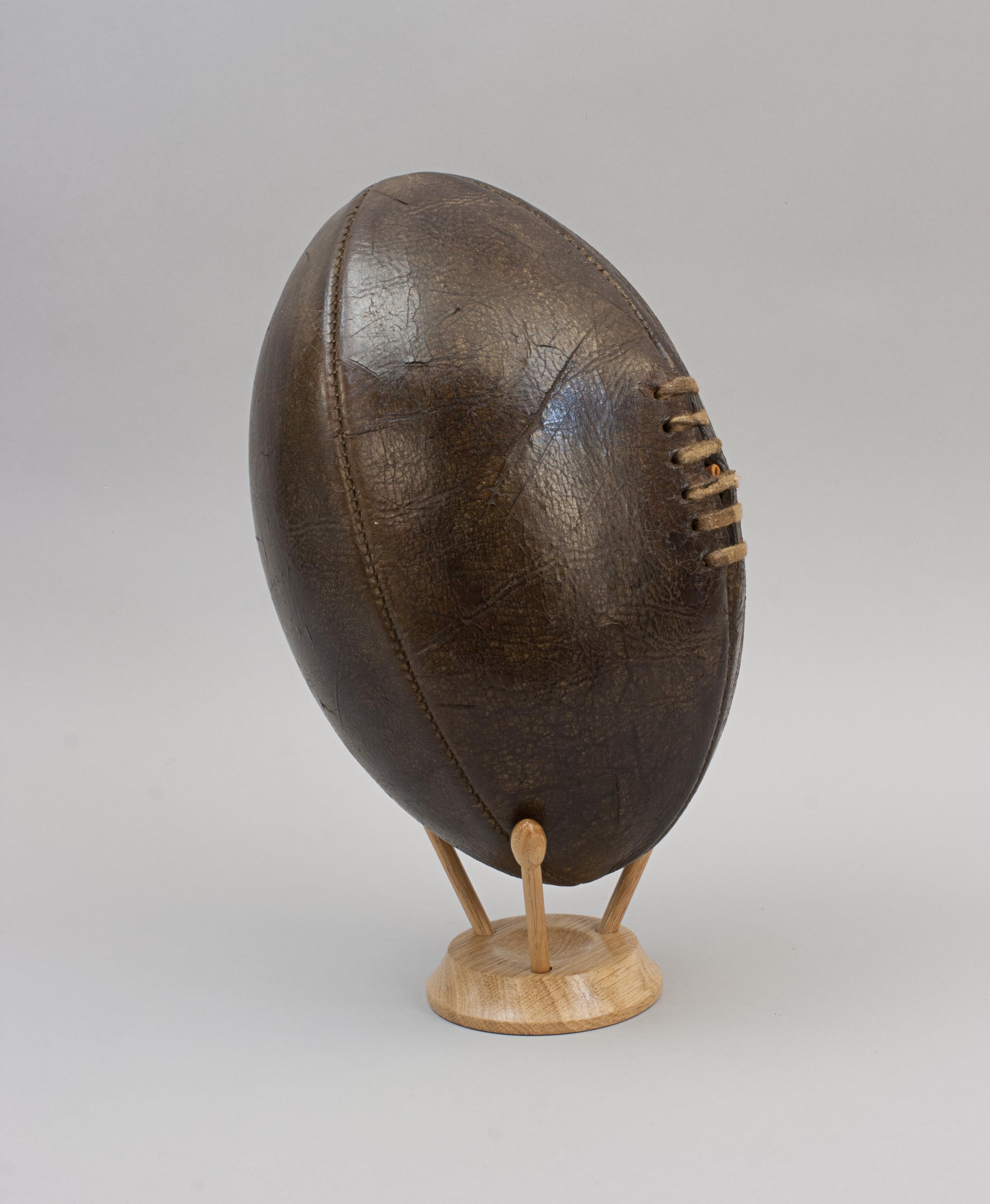 Original Antique Leather Rugby Ball.
A beautiful leather rugby ball made with the traditional four leather panels with good dark colour and patina. The ball has a lace-up slit to the front that would have enabled bladder inflation, there is an