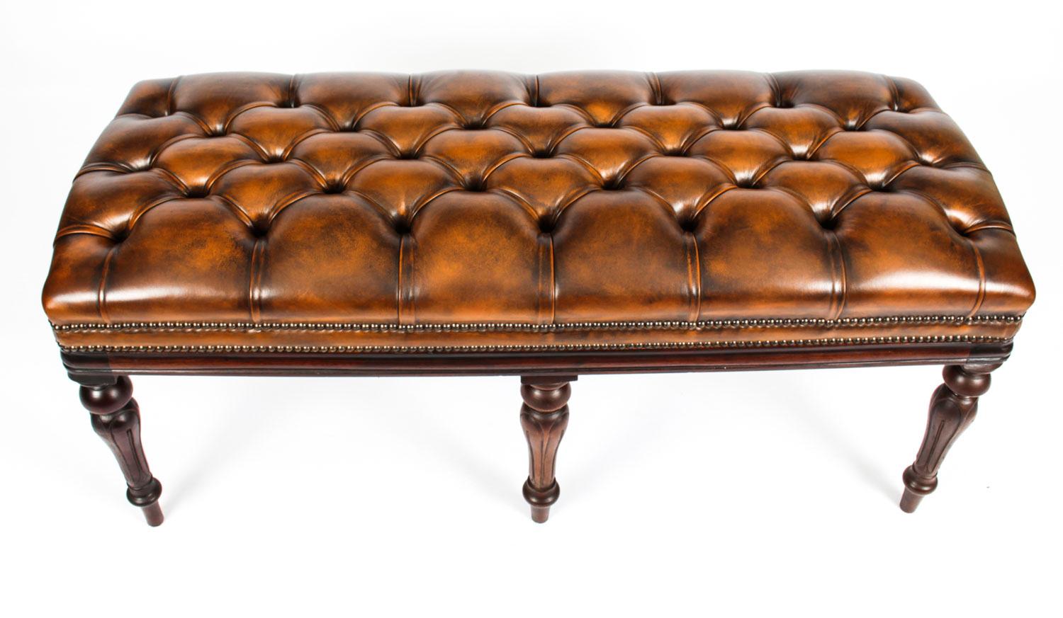 This is a very handsome leather window seat / ottoman, Circa 1890 in date.

It features a fantastic mahogany frame with turned legs and sumptuous dark tan buttoned leather upholstery.

 Condition:
In excellent condition having been