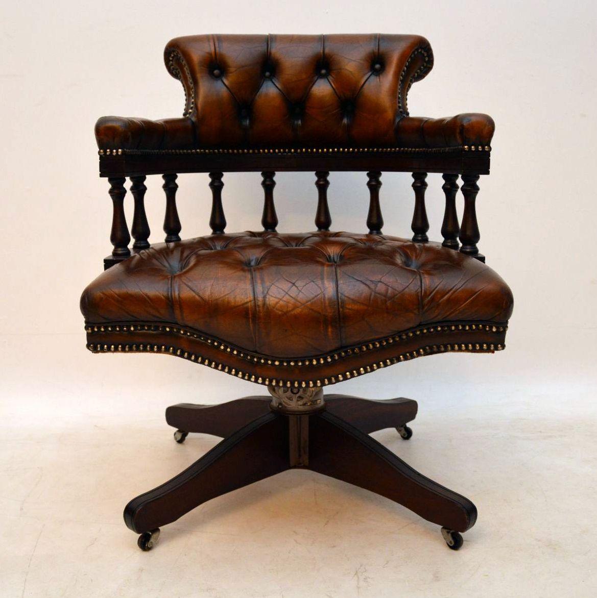 Antique deep buttoned leather swivel desk armchair in good original condition. The leather is all original, with no splits, holes or tears and is naturally distressed, so full of character. The frame is mahogany as are the legs, which sit on