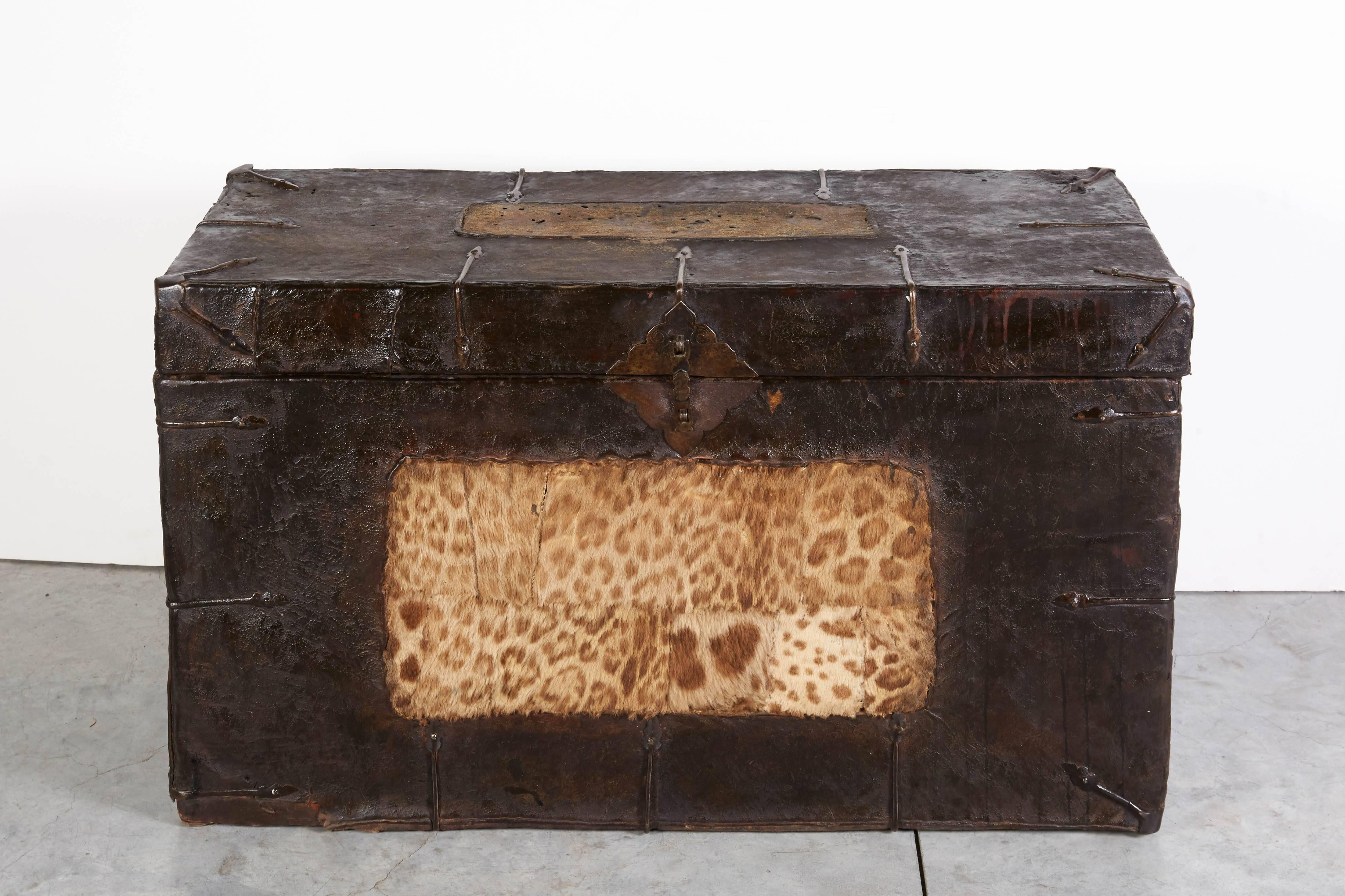 An unusual antique leather Tibetan trunk with tiger skin panel in front, original iron hardware throughout and beautiful wooden interior. Great decorative piece with practical uses.
B357.