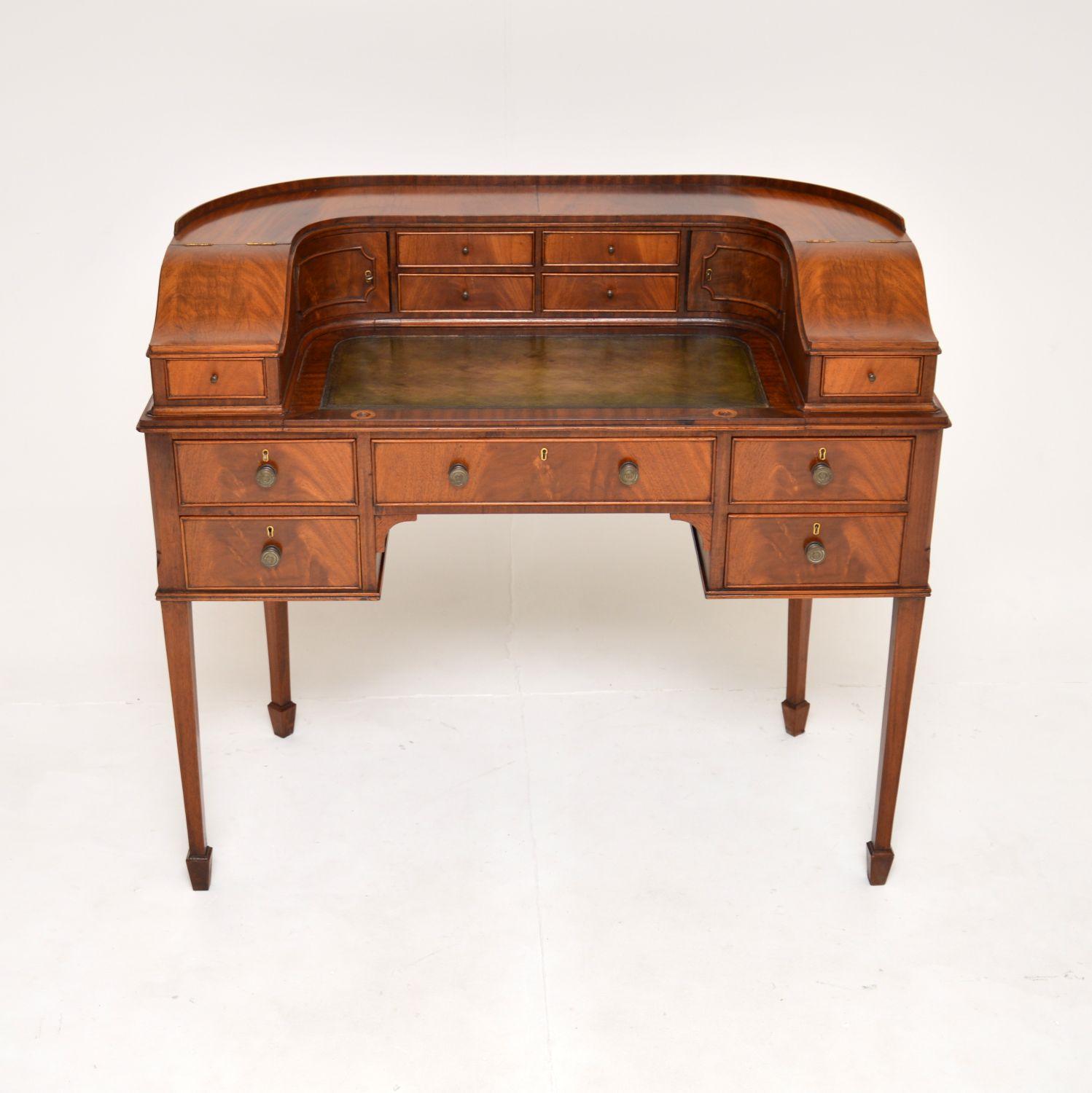 A superb antique Carlton House desk. This was made in England, it dates from around the 1900-1920 period.

This is of amazing quality, it is very well built and heavy. There are five generous drawers in the lower section, with ten smaller drawers