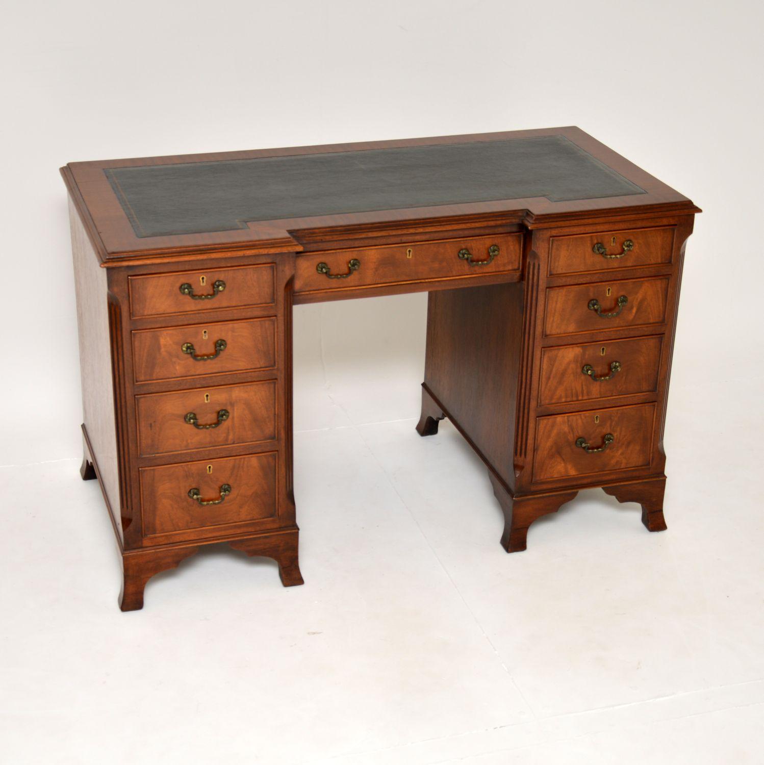 A superb antique leather top desk in wood. This was made in England in the Georgian revival style & I would date it to around the 1910-20’s period.

The quality is fantastic, this is very sturdy and well built. It is one fixed piece, the front has