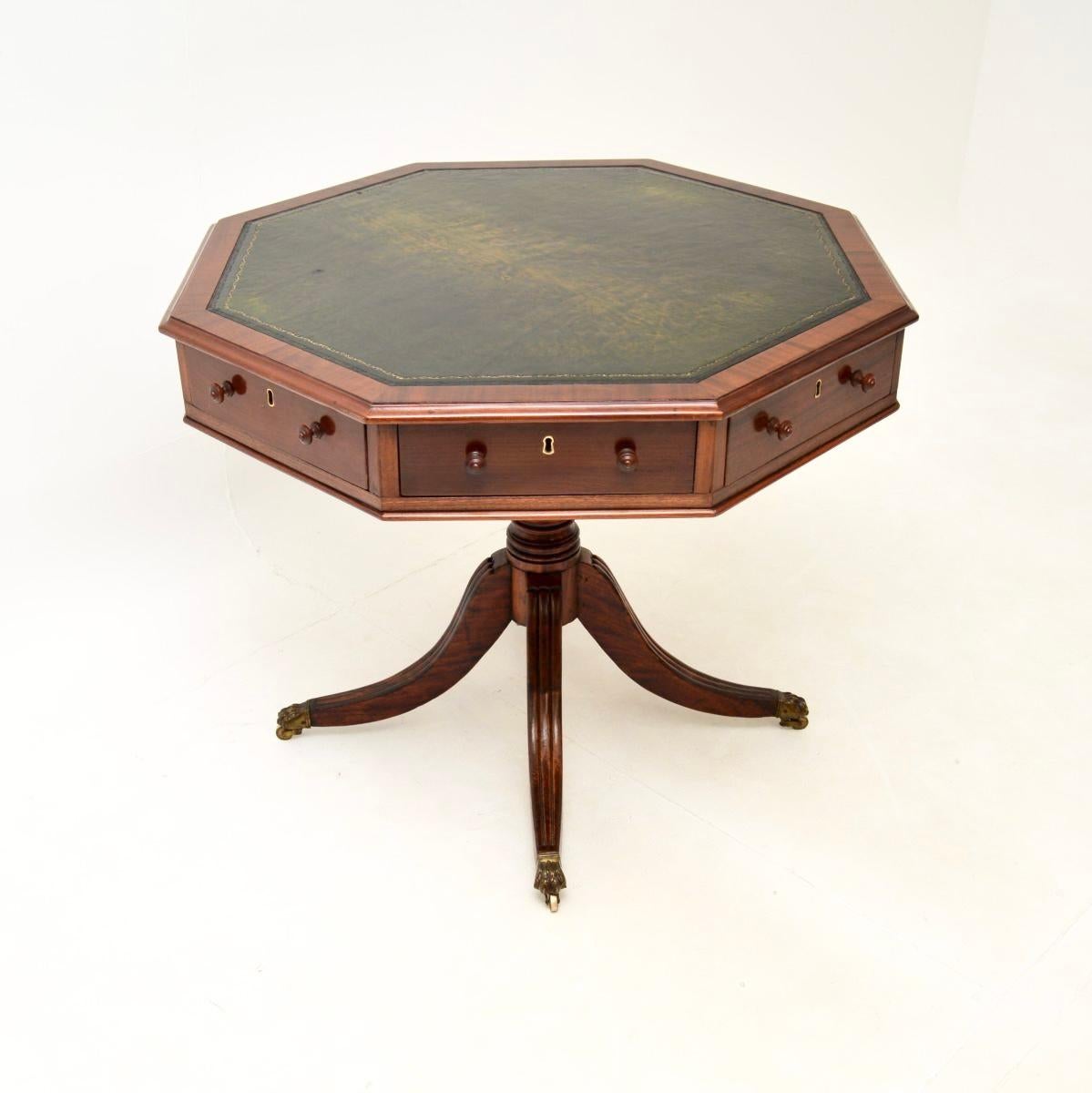 A smart and extremely well made antique leather top drum table. This was made in England, we would date it from around the 1910-20 period.

It is a great size and is of superb quality. The octagonal top revolves on the base, it has cross banded