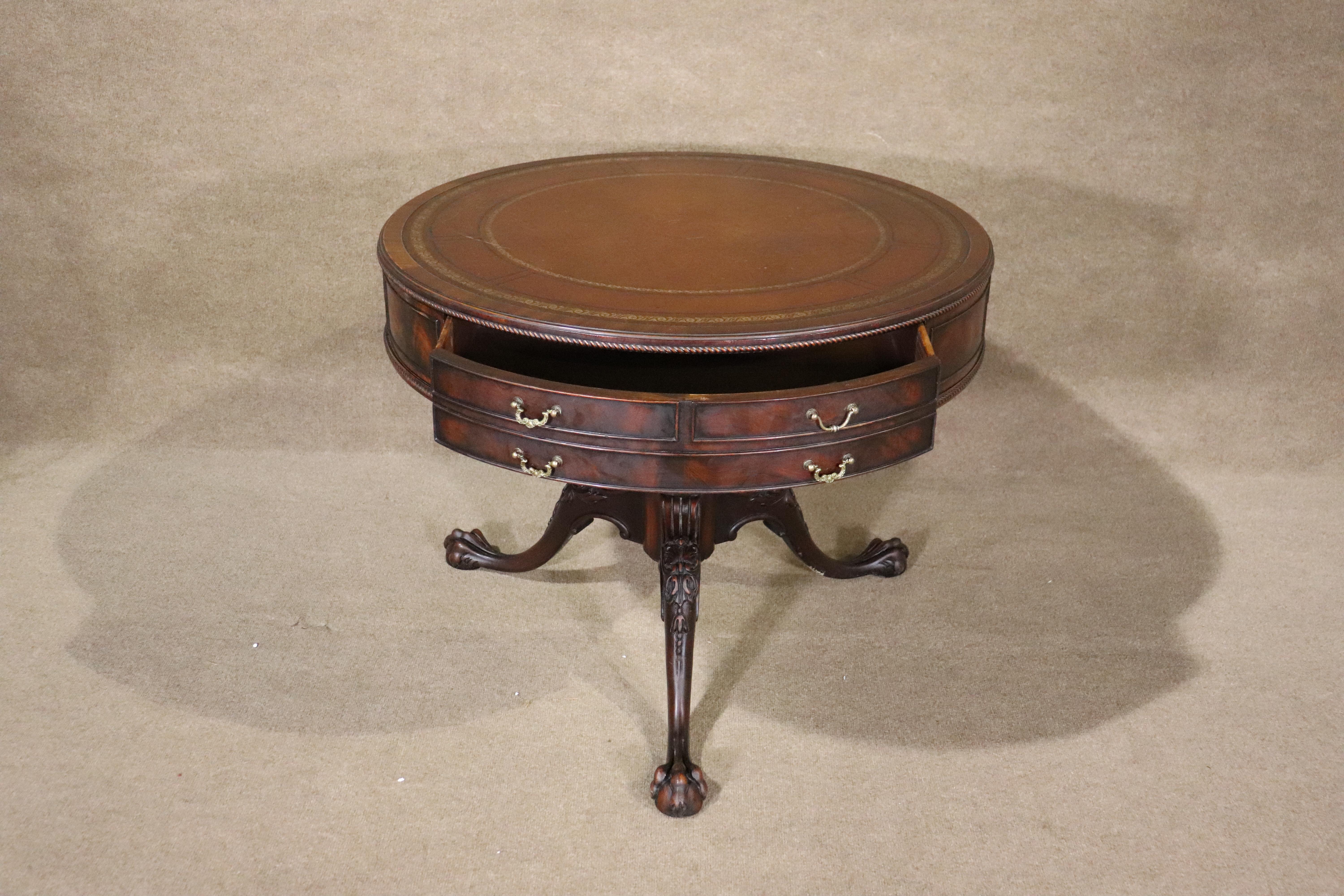 This round drum table features aged leather top, storage drawer and carved claw feet. The frame is carved mahogany with brass hardware and a carved base.
Please confirm location NY or NJ