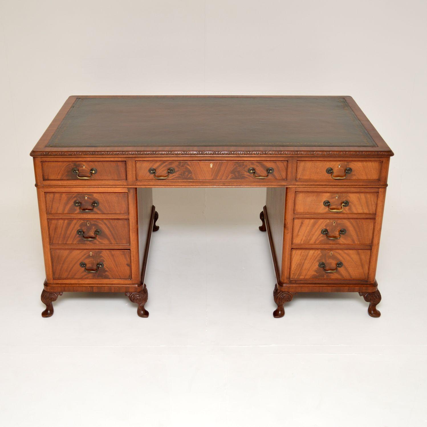 An excellent large antique pedestal desk. This was made in England, it dates from around the 1920-30’s.

The quality is fantastic and this is a great size. The wood has beautiful grain patterns, and fine carving around the top edges and cabriole