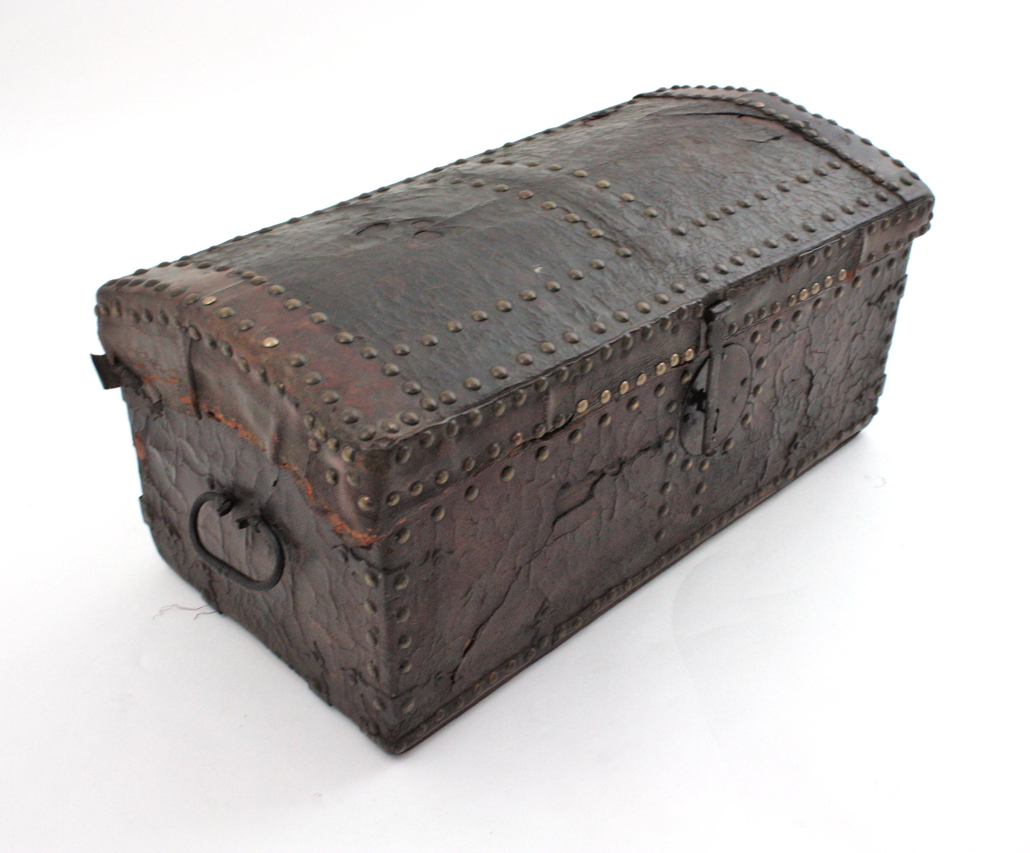 Dome Top Leather Trunk with poychrome hand Painted Scene, early 20th century.
A gorgeous traveling trunk from France with a hand painted horse carriage landcape at the lid.
Wooden trunk upholstered with brown leather and brass tacks, wrought iron