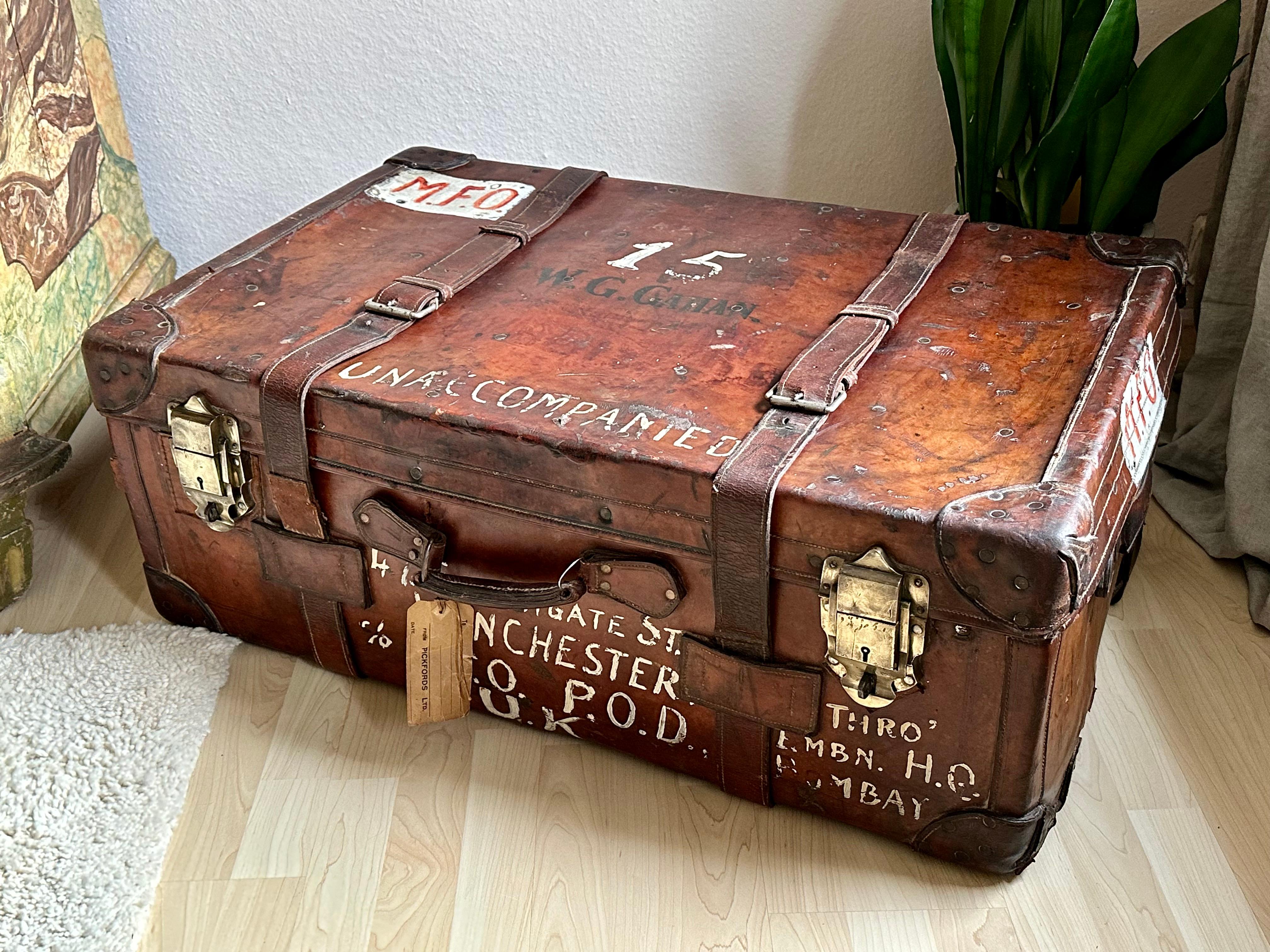 Embark on a journey through time with our extraordinary overseas trunk, a living relic that whispers tales of a century past. Crafted from rich dark brown leather, this substantial piece, now a century old, boasts an exceptionally beautiful patina,