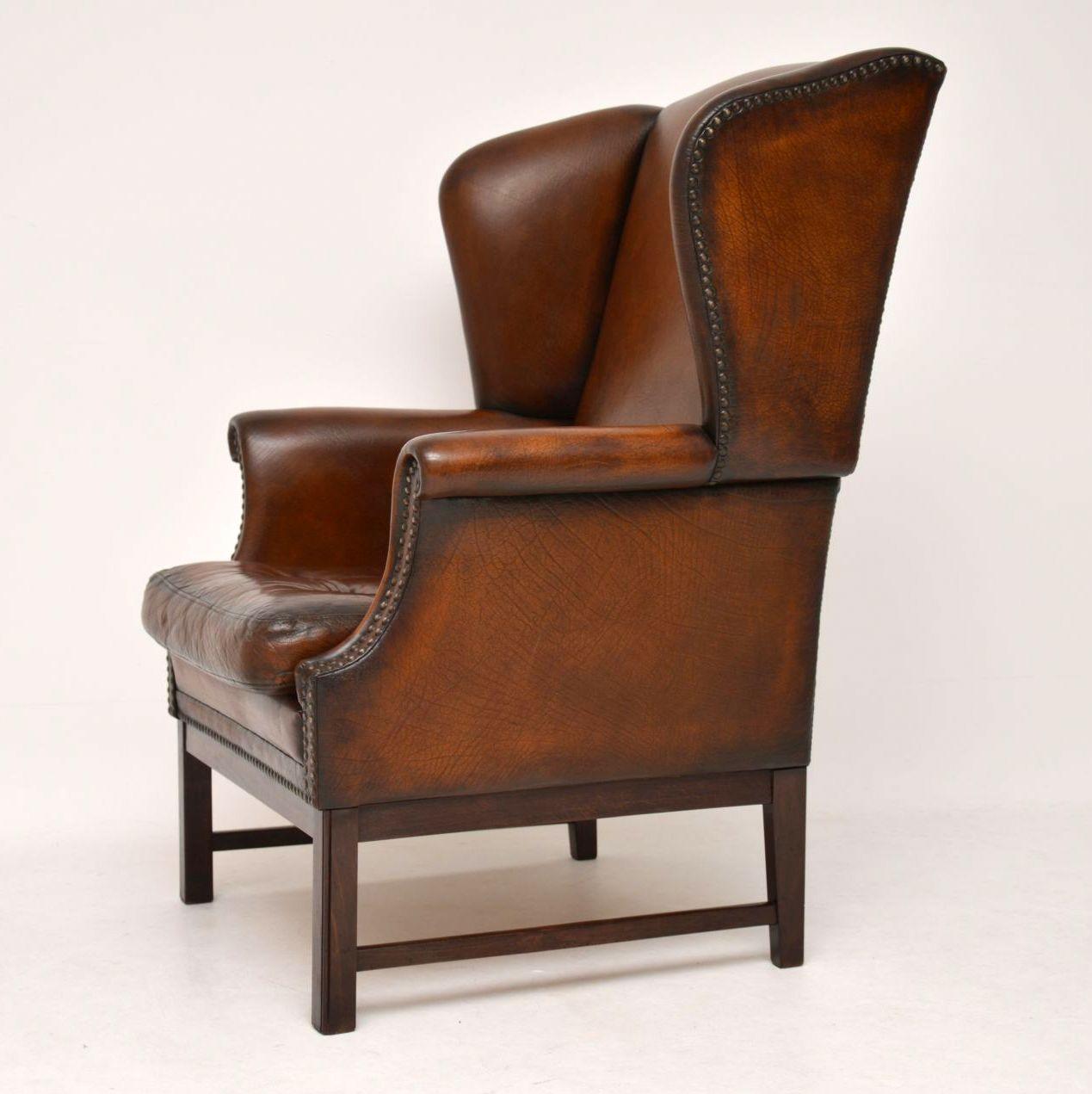 Very comfortable antique leather wing armchair in good original condition and dating from around the 1930s-1950s period. The leather has been professionally polished and color enhanced, so it has a lot of character. The seat is buttoned and the