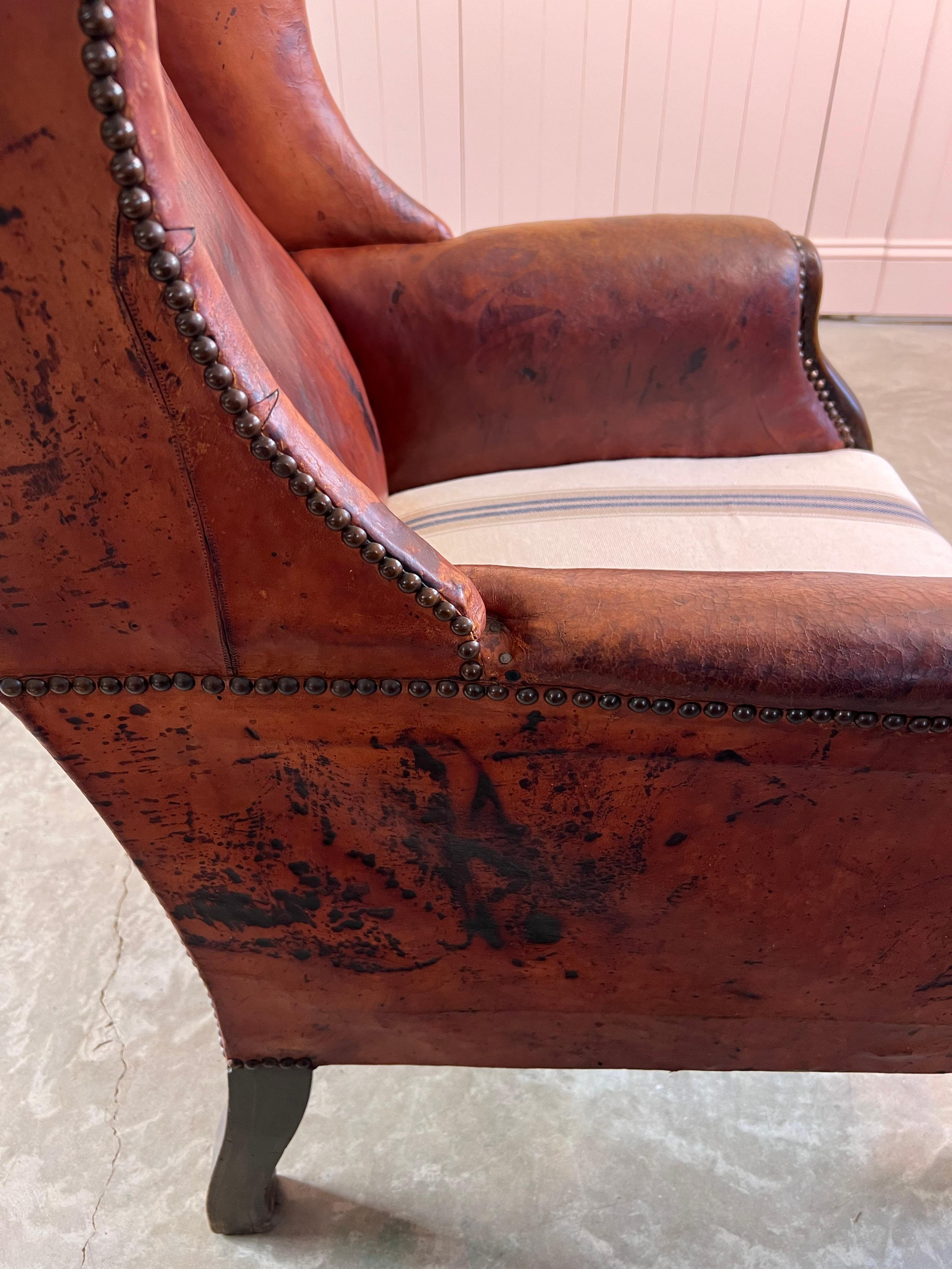 Antique Leather Wingback Arm Chair In Fair Condition For Sale In Cirencester, GB