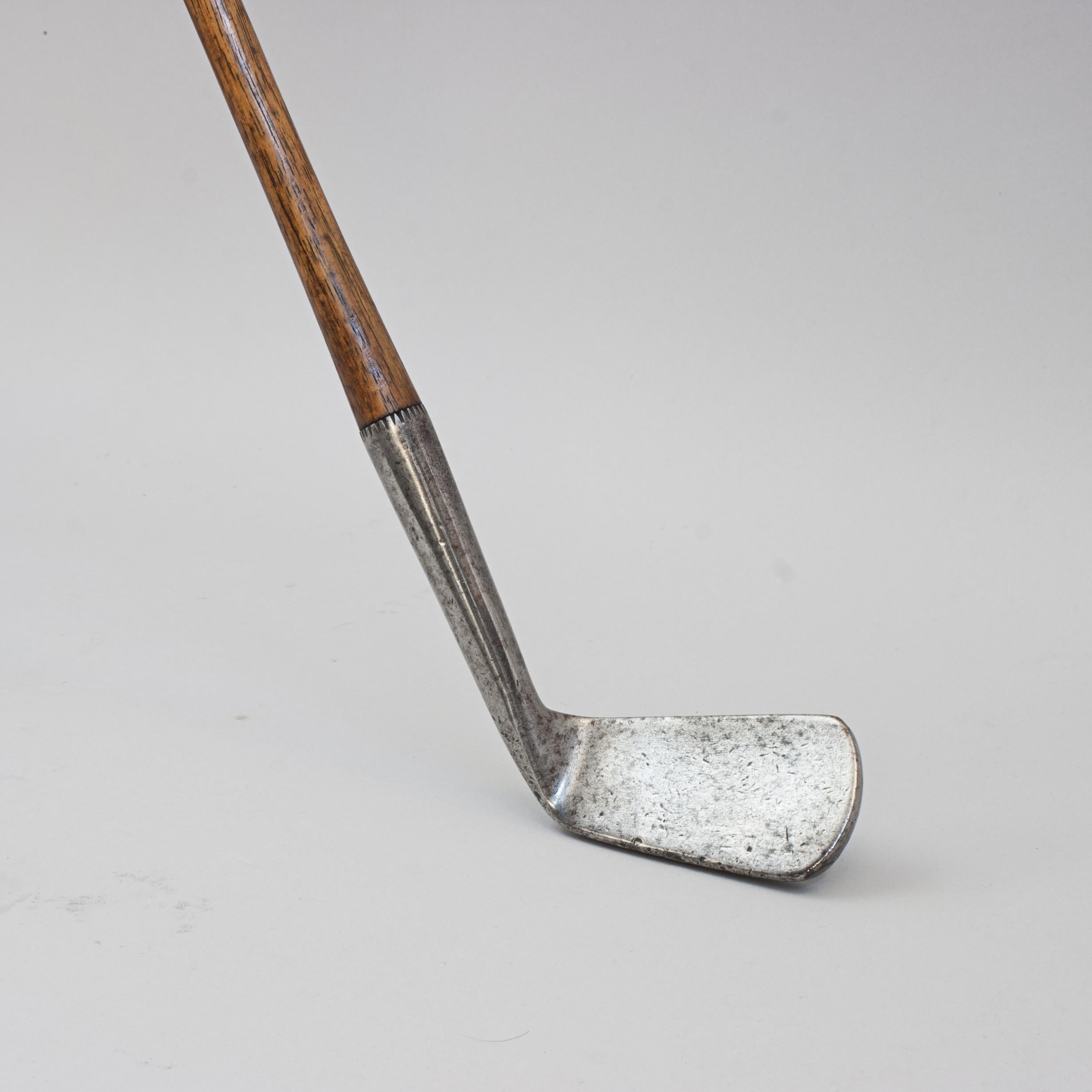 Willie Park Left Handed Smooth Face Golf Club.
This early Willie Park Jr. hickory shafted lofting iron has a smooth face, original hickory shaft and the remains of the original sheepskin grip. This is a fine example of an early lofting iron with a