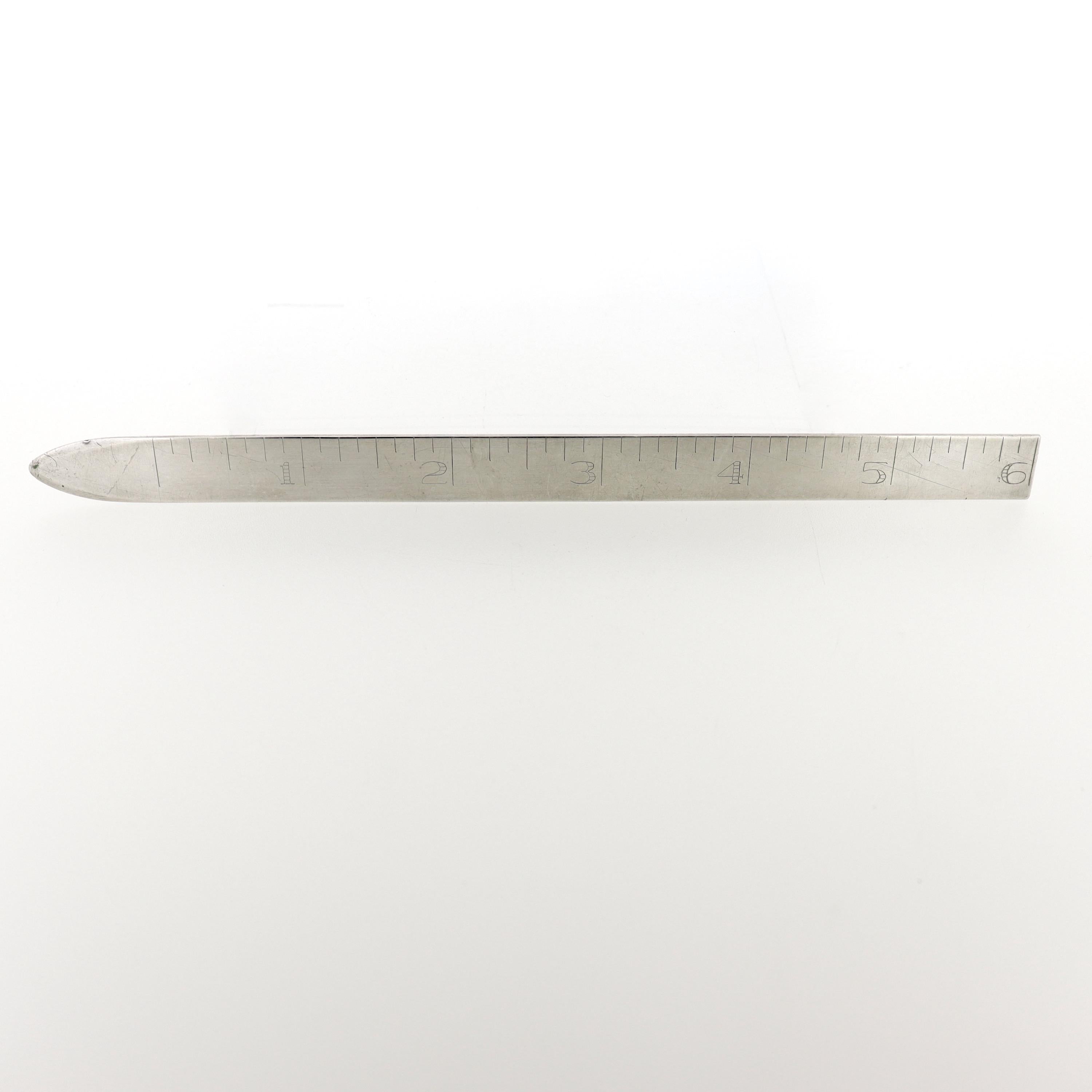 A fine antique sterling silver ruler.

By Leonore Doskow.

With a pointed end for opening letters and 6 inches of measurement marks.

Simply a great dual-purpose letter opener & ruler from Leonore Doskow!

Date:
20th Century

Overall Condition:
It