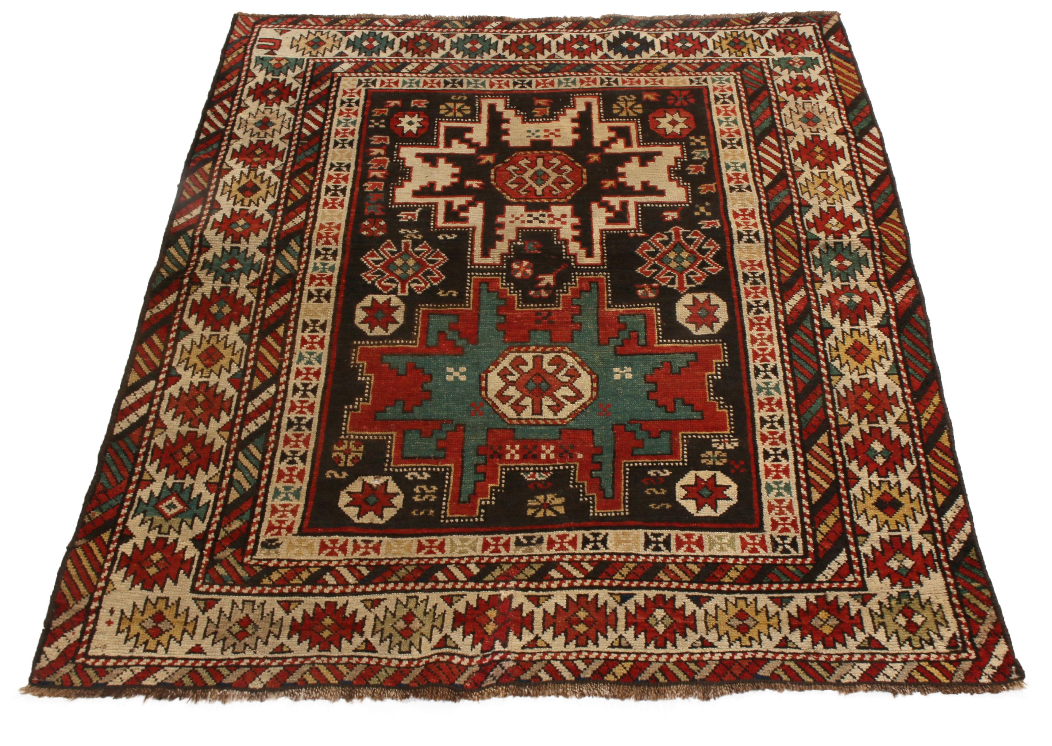 Originating from Russia in 1900, this antique traditional geometric rug features a distinct Lesgi Star design in tribal red, blue, beige, and black colorways. Hand knotted in high quality wool, this design dates back to as early as the 16th century,