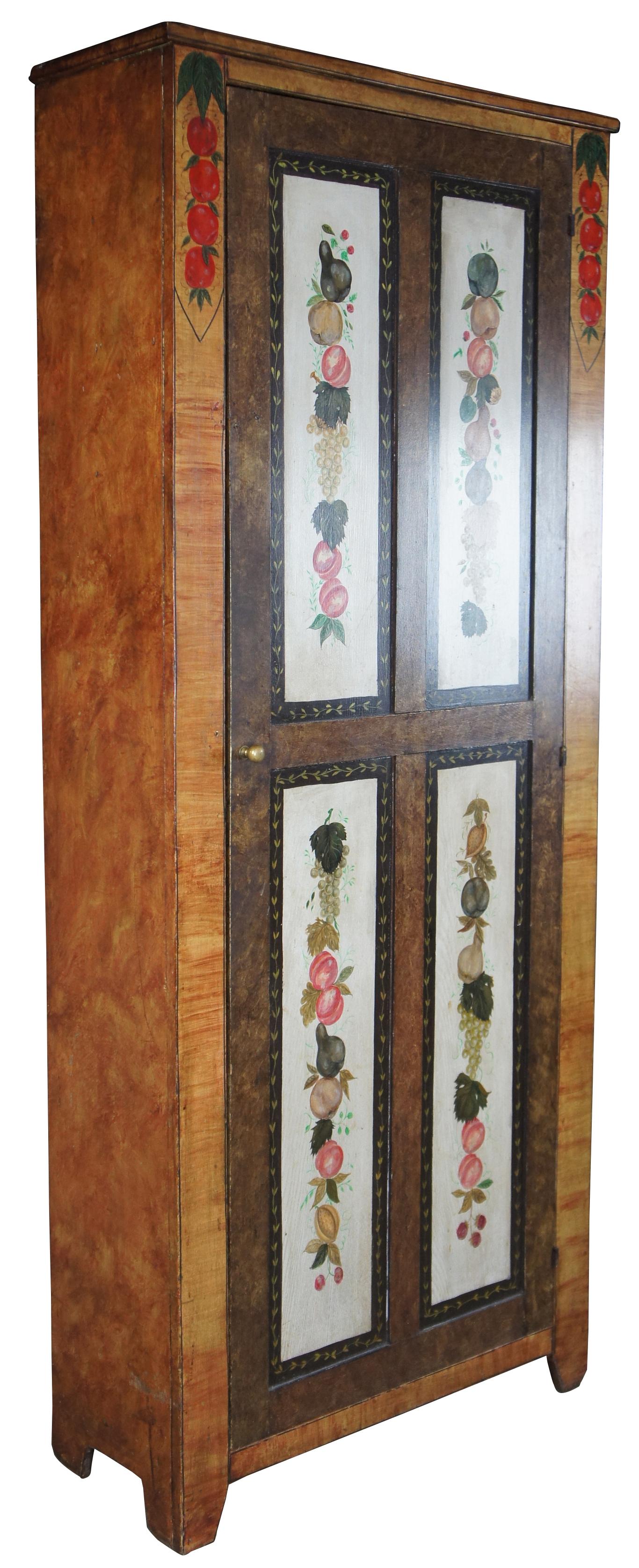 Antique American pine cupboard. Features a faux painted grain and fruit motif by Lew Hudnall of Dayton Ohio. The paneled door opens to seven shelves.
  