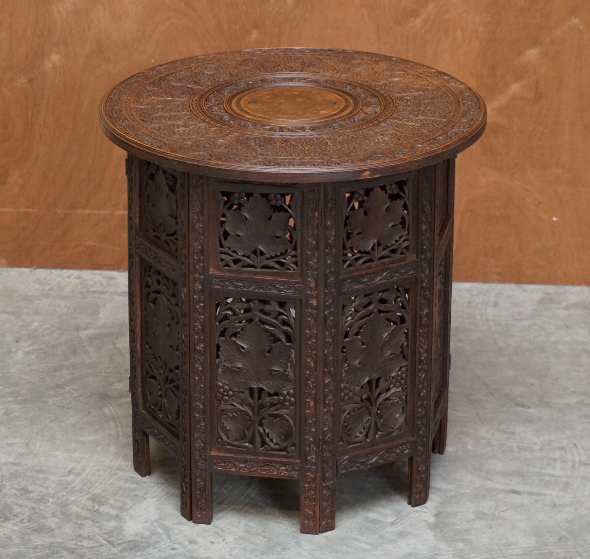 We are delighted to offer for sale this lovely and rare Syrian hand carved folding table retailed through Liberty's London circa 1880

This piece is a good sized decorative table, ideally suited simply for decoration or as a lamp table, the timber