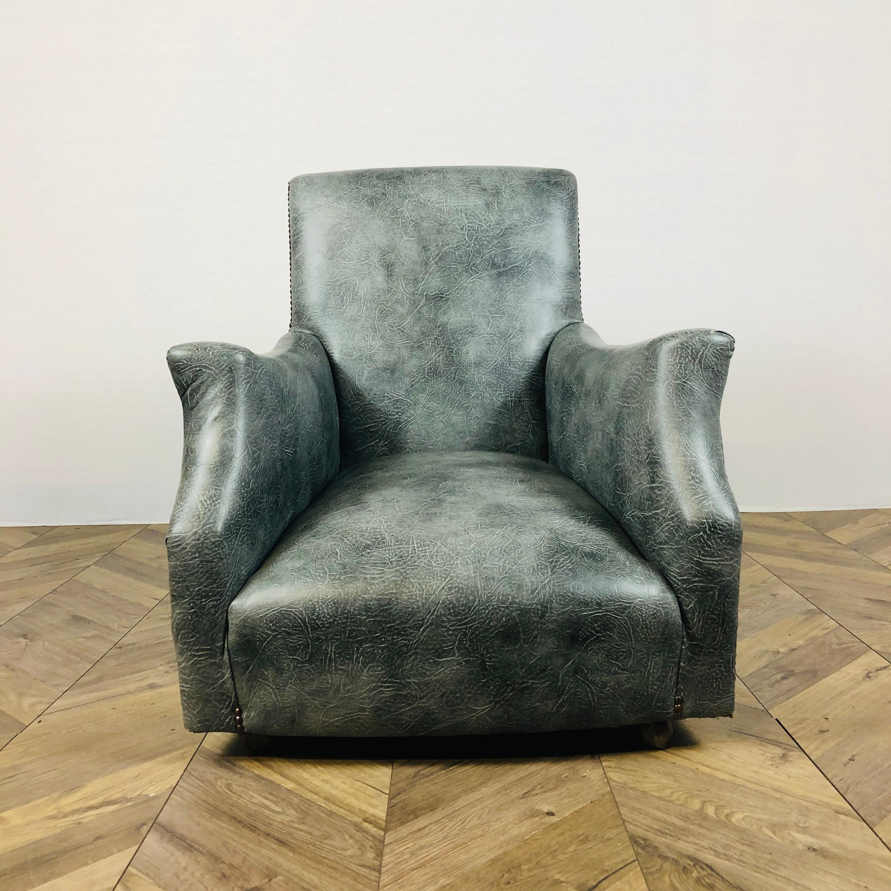 An unusual and super comfortable, late Victorian library armchair.

The armchair has a wonderful shape, which has been completely refurbished in the 1960’s. The upholstery was professionally updated to a textured grey vinyl fabric and the legs