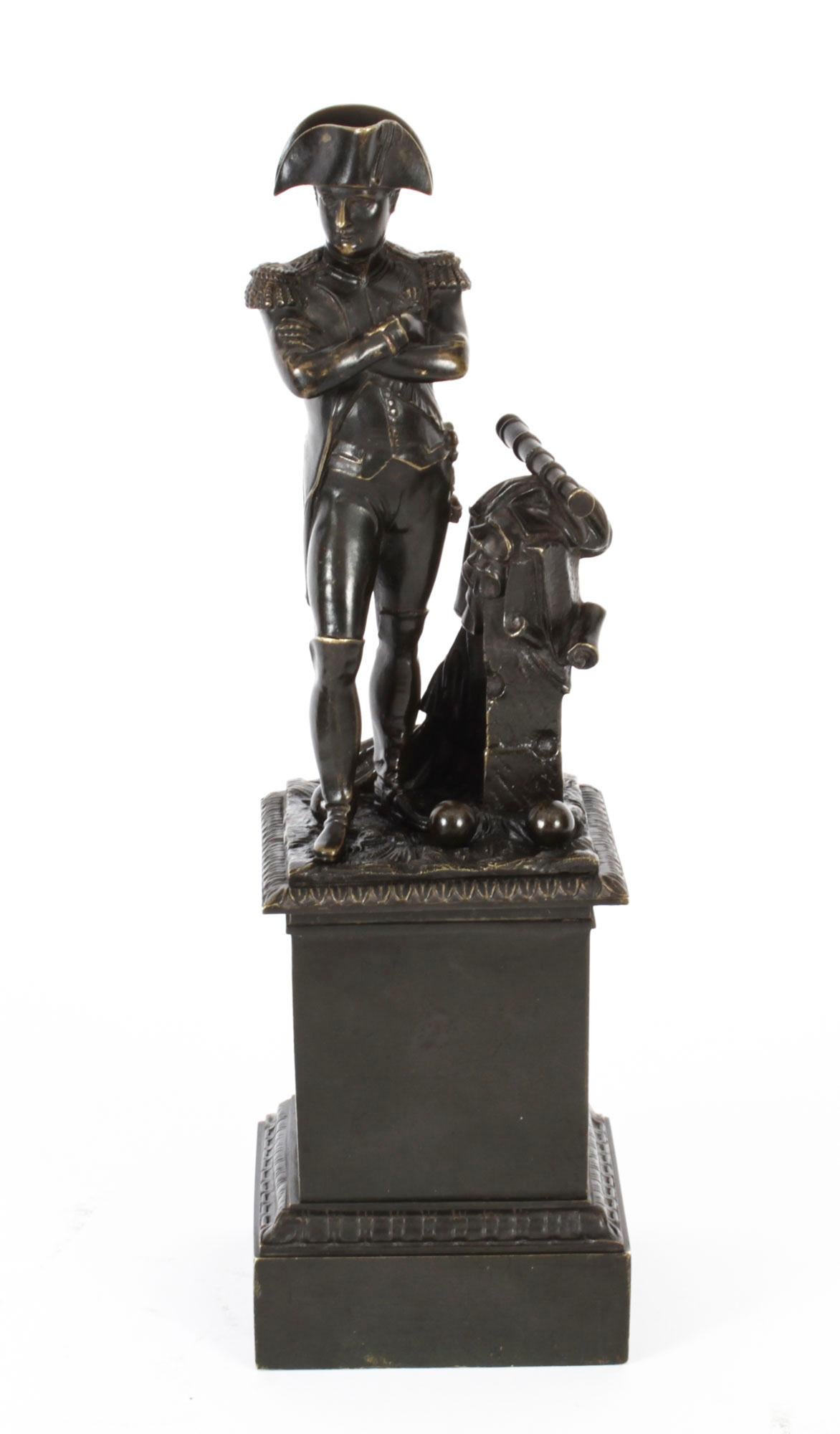 This is a finely cast brown patinated bronze Grand Tour sculpture of Napoleon Bonaparte, Mid 19th Century in date.
 
It features Napoleon standing contrapposto in uniform wearing a bicorn hat and knee-high boots. He stands on a decorative
