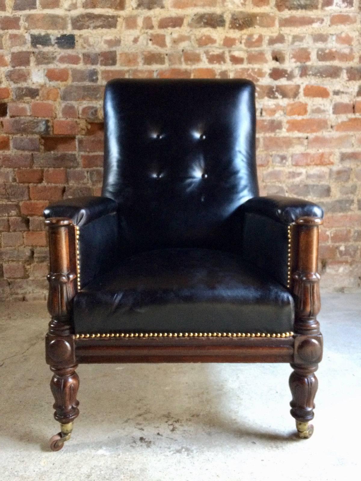 A sublime William IV mahogany library or drawing room chair upholstered in black leather with button back and raised on moulded tulip supports with original casters, offered in excellent condition.