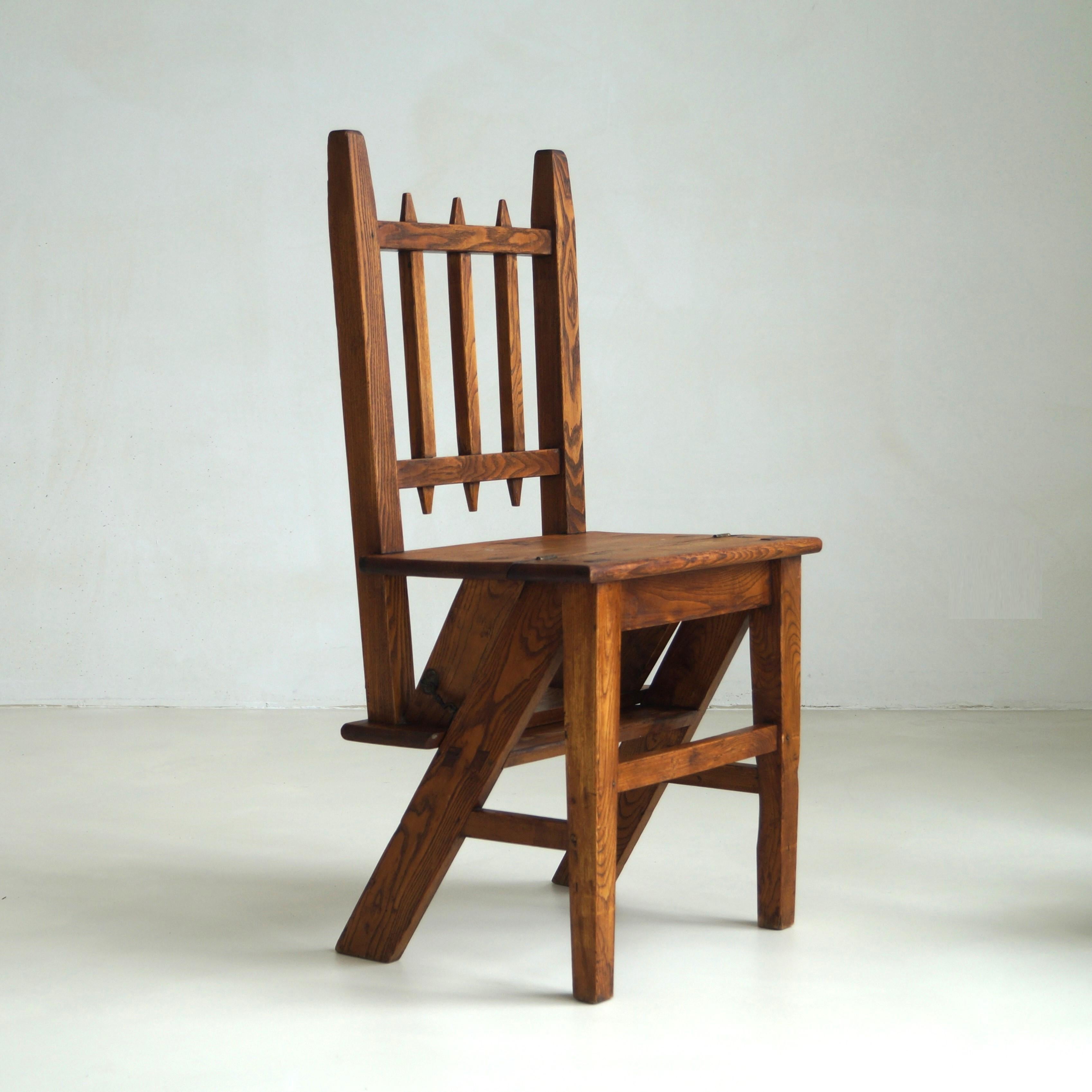 An unusual designed and  exceptionally well made Arts & Crafts library steps chair, Netherlands, around 1910. 
With a minimalistic appearance seen from the back, front and side, when it's placed in an angle it shows the well made construction to