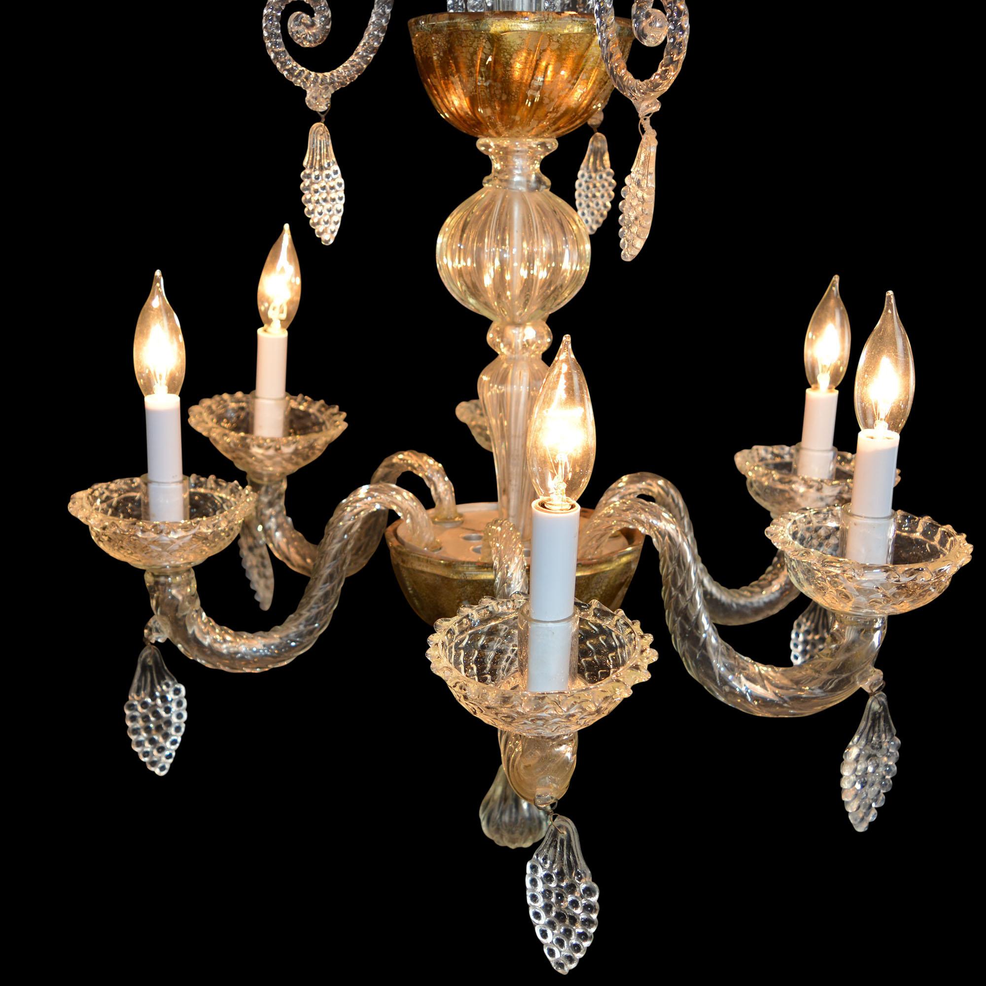 Beautiful antique chandelier originally fitted for gas but was later converted to electricity features 6 lighted arms and an additional 6 decorative arms. In 2019, it was converted for US electricity. It is Liege glass which known for its detailed