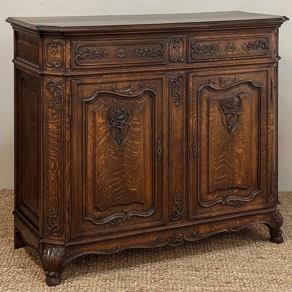 Antique Liegoise Louis XIV Oak Buffet is a splendid example of the time-honored quality craftsmanship that has been a hallmark of the region around Liege for centuries.  Hand-carved from indigenous white oak, it features recessed, mitered corners,