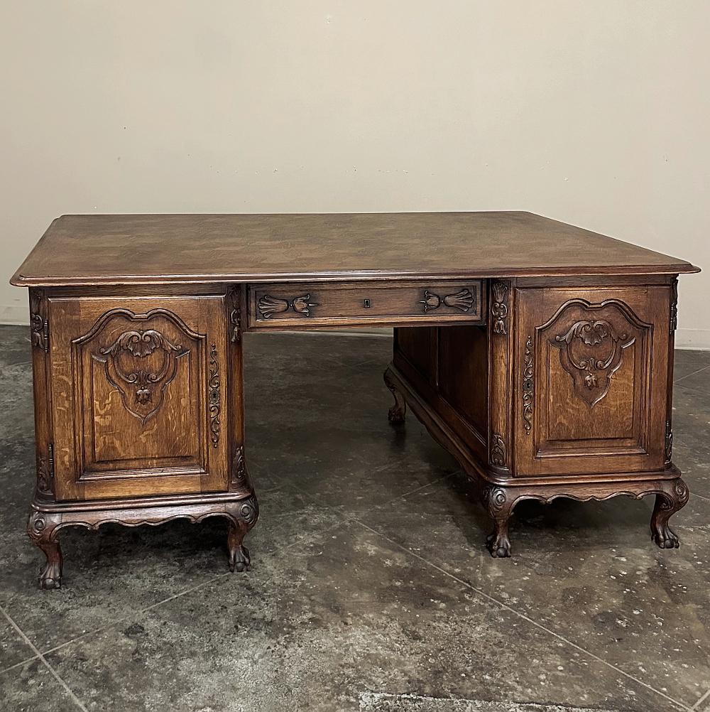 Antique Liegoise Louis XIV Oak Parquet Partner's Desk is the perfect choice for those who desire an efficient yet attractive office!  Hand-crafted from solid oak with a durable parquet work surface, it features access from both sides with each