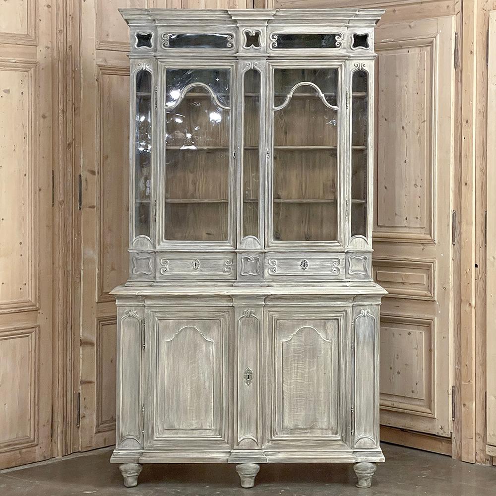 Antique Liegoise Neoclassical Whitewashed Bookcase ~ Display Cabinet is an intriguing design, featuring a tailored expression of an architectural form that dates back thousands of years, melded with subtle scrollwork expressed in molding detail.  A