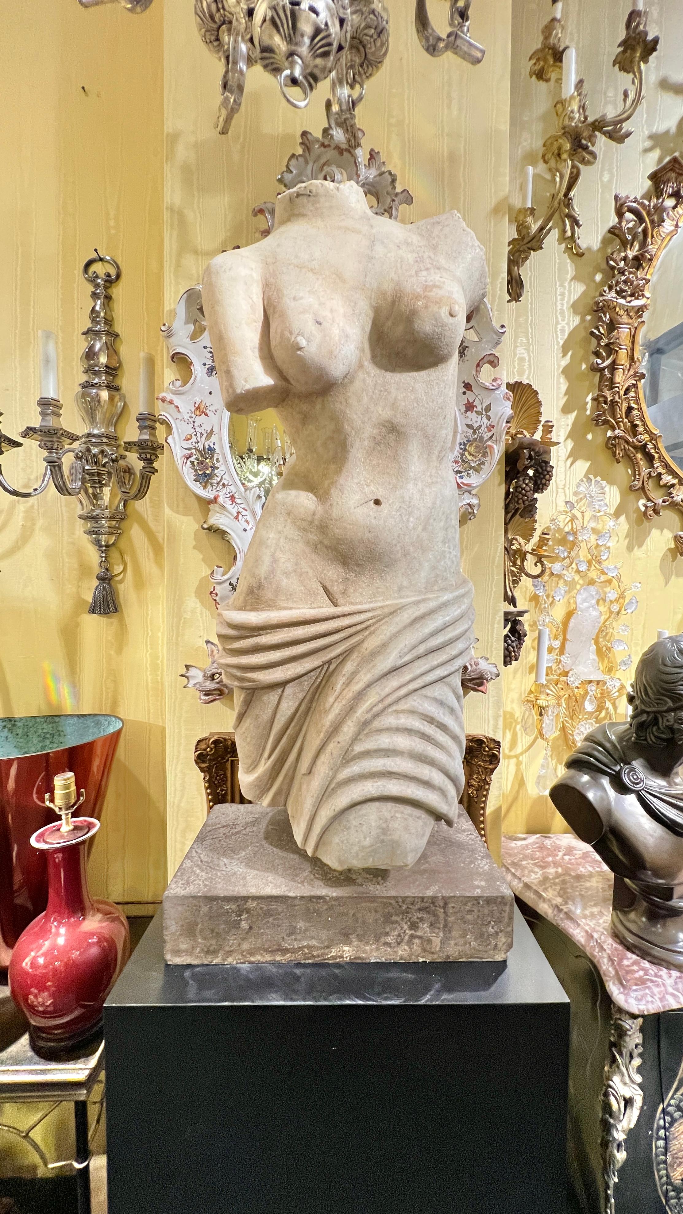 Large antique continental marble statue depicting the torso of Venus, after the ancient Roman work, the Venus de Milo, measuring 33 inches tall.  Unsigned.