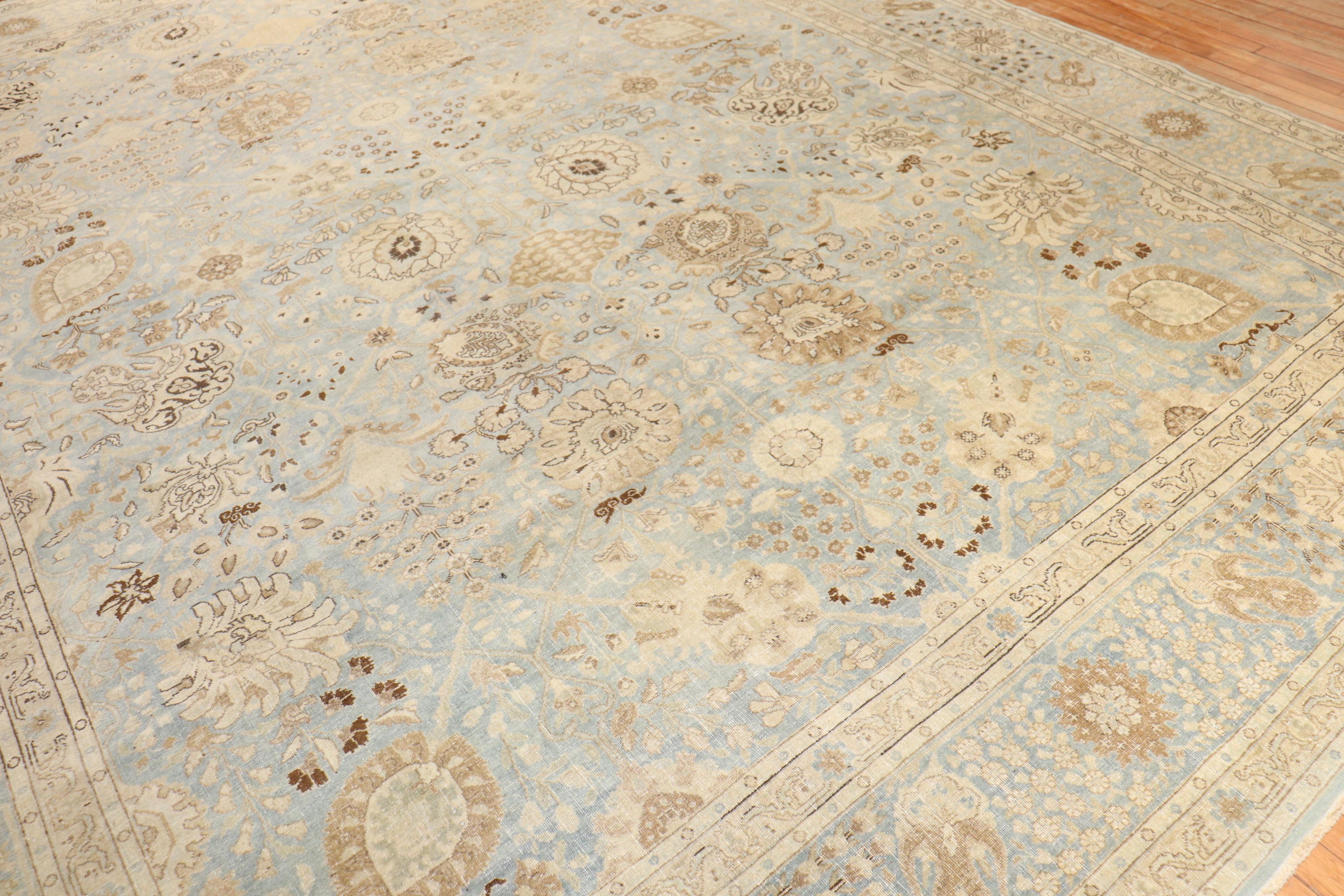 An early 20th Century Persian Tabriz rug with an elegant all over design on a light blue ground. Dominant accents in ivory, brown and yellow

10'10'' x 14'6''