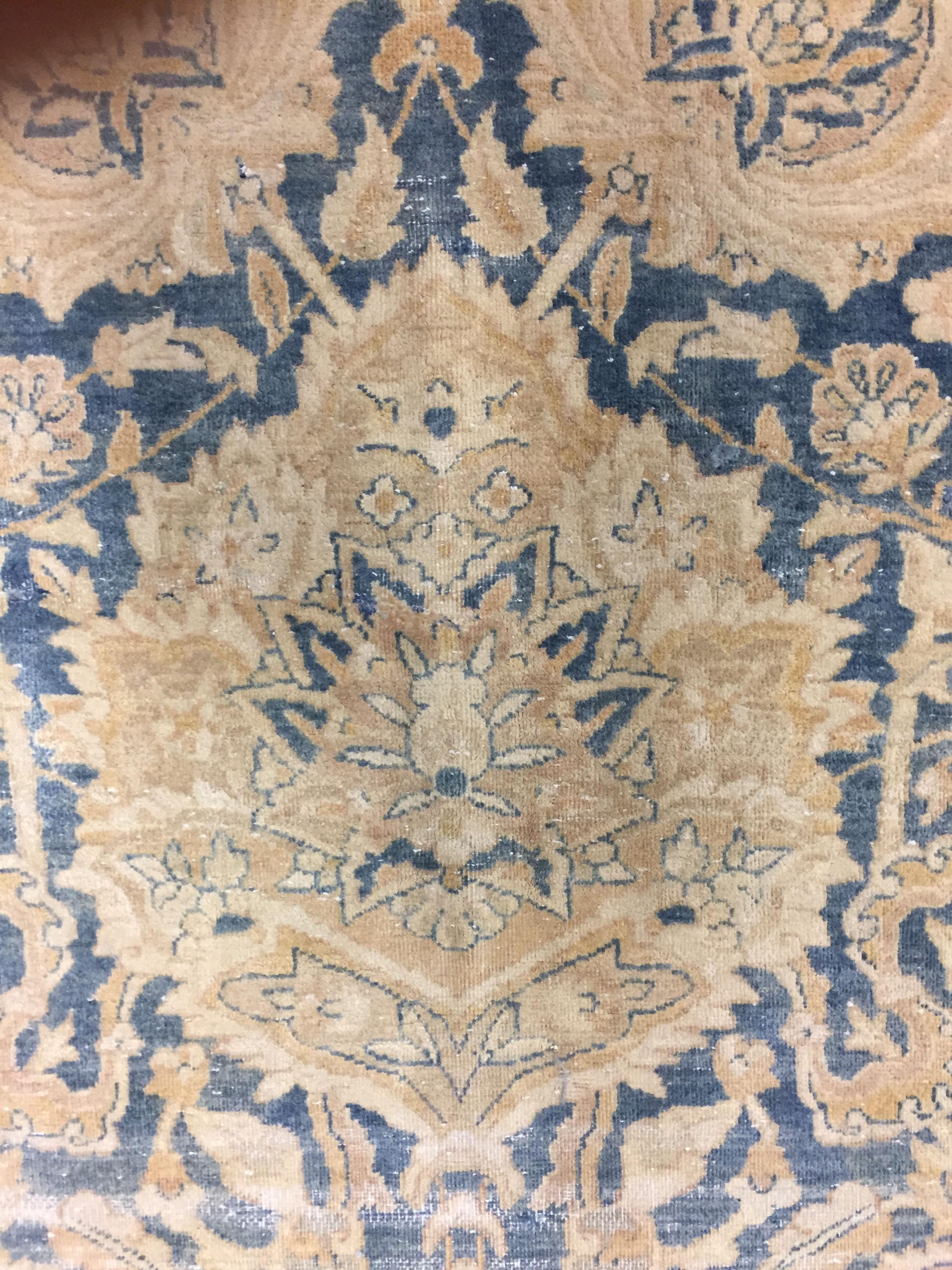Antique lightly distressed Persian Kirman rug, circa 1890, 9'10 x 13'. From Kirman in Persia this is an antique, circa 1890 hand knotted rug. The condition is distressed, shabby chic. The rug is solid but with low pile and a distressed look that