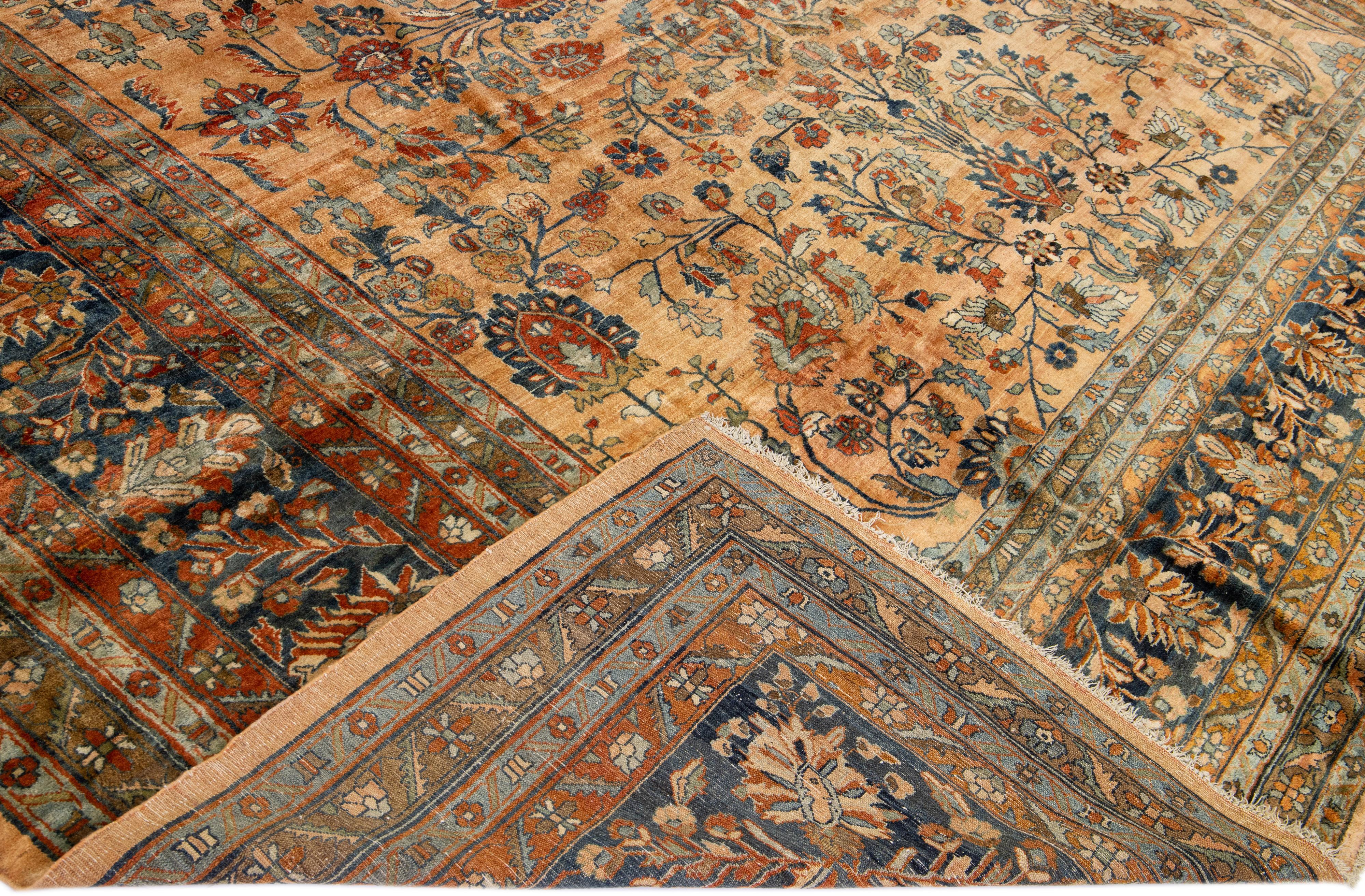 Beautiful antique Lilihan hand-knotted wool with a peach field. This Persian has blue borders with an all-over floral pattern design in blue and red accents. 

This rug measures: 13' x 20'6