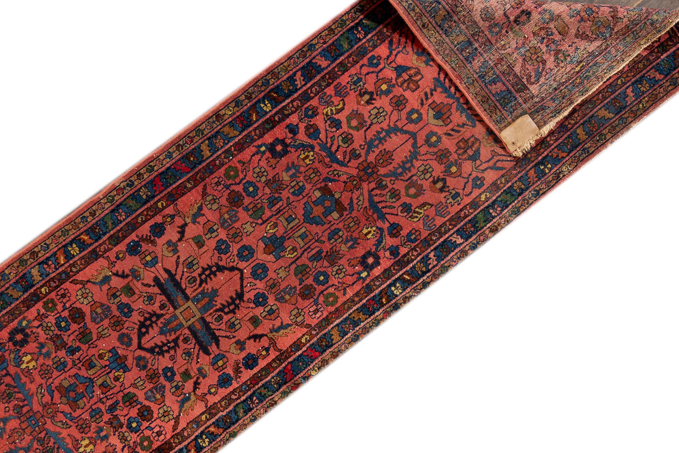 A 20th century antique Lillihan rug with an all-over pink motif. This rug measures at 2'7