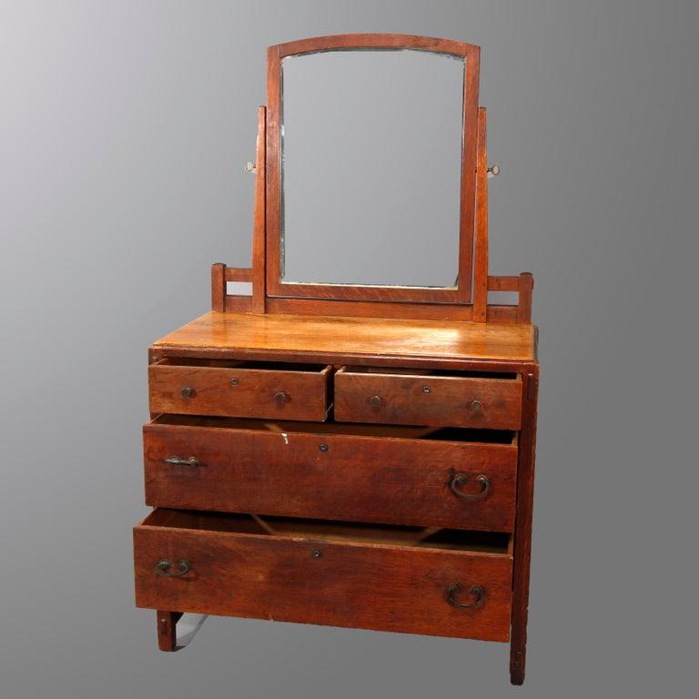 An antique Arts & Crafts mission oak chest of drawers by Limbert offers slightly arched mirror surmounting two over two case raised on square and straight legs, without label, guaranteed Libert, circa 1910. 

Measures-67.25