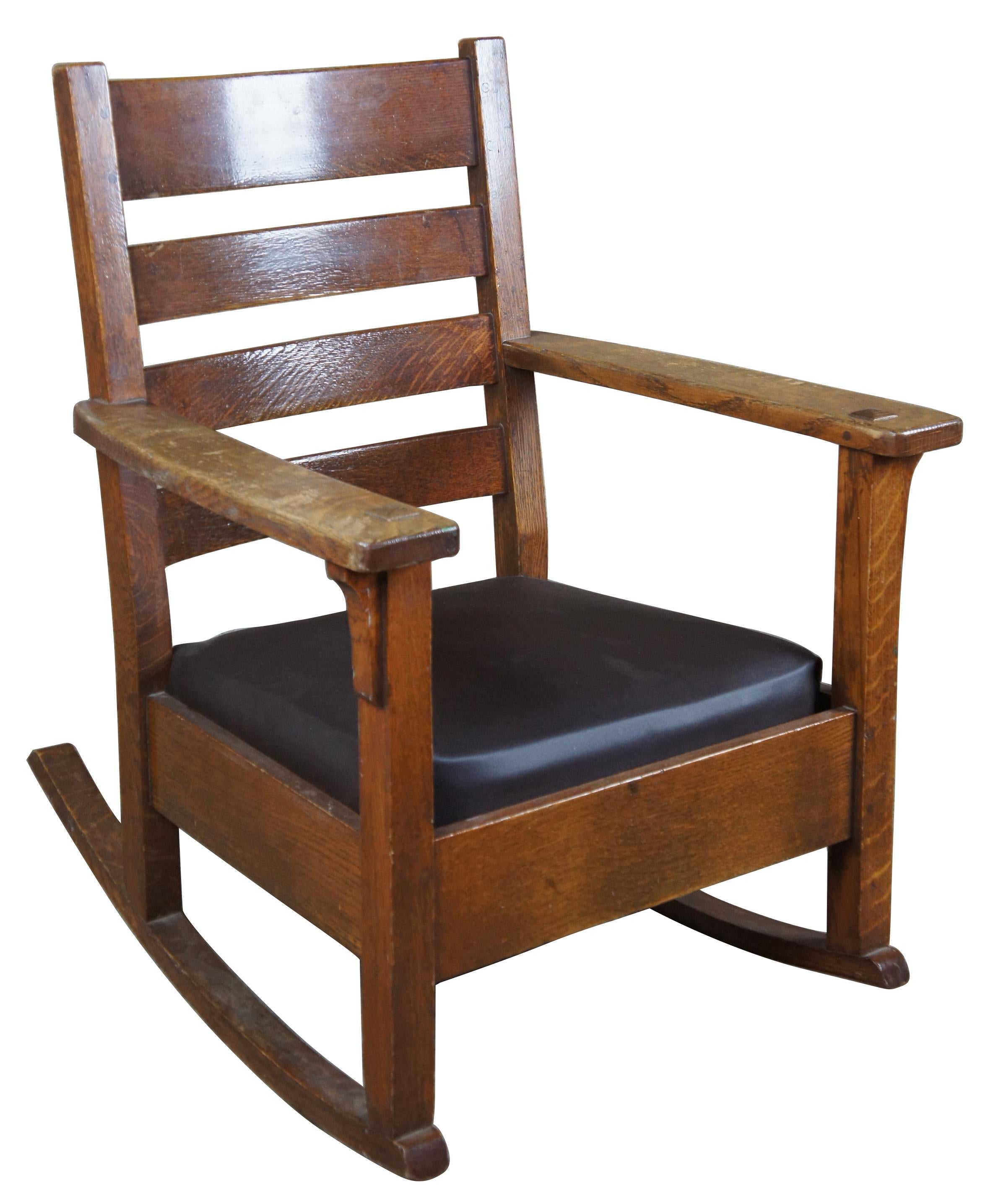 Limbert rocker, circa 1920s. Made from quartersawn oak with vinyl seat, stamped along underside of arm. Charles P. Limbert was an American furniture designer. He is considered one of the most successful furniture leaders in the history of Grand