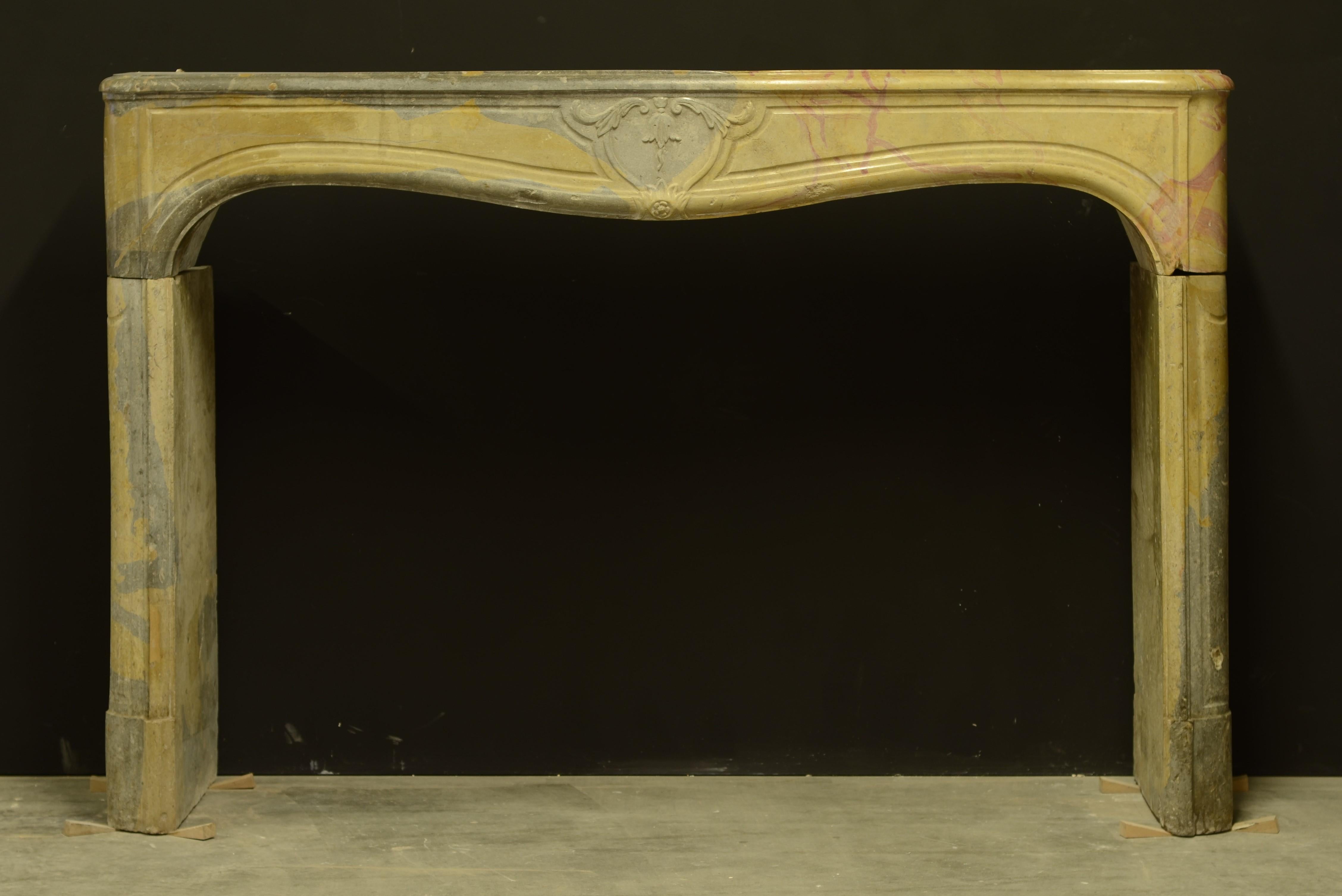 Antique limestone fireplace, 18th century Louis XV, France.

This lovely bi-color limestone fireplace from the Burgundy area in France is very elegant and subtle decorated. Its simple slim legs support the frieze with a beautiful central