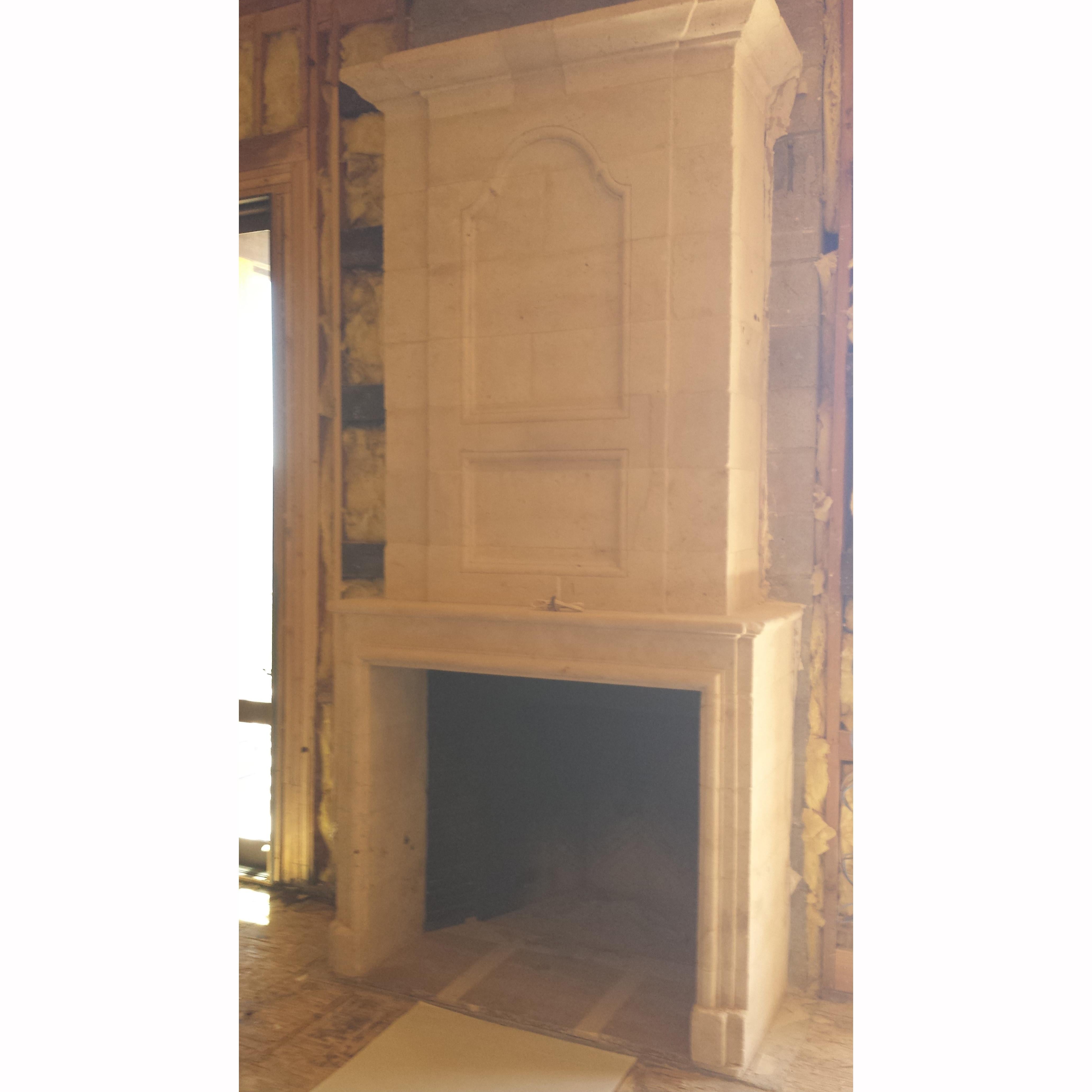 Rectilinear antique limestone fireplace and cheminee with rectilinear firebox. 