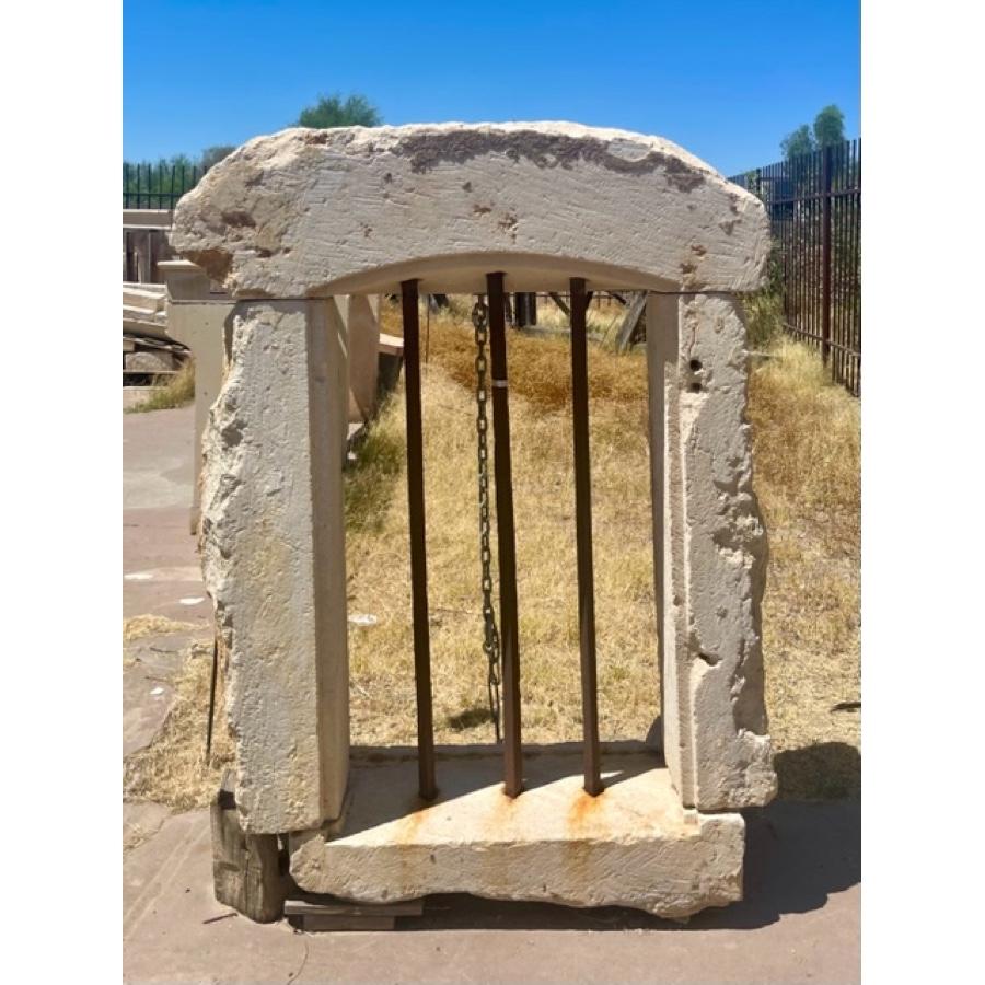 Antique Limestone Window Surround with Iron Bars
Dimensions:  
- Overall:  APPROX - 56”H x 44”W x 23”D
- Interior:  APPROX - 38 3/8”H x 25 3/8”W x 23”D

Beautiful texture and patina.