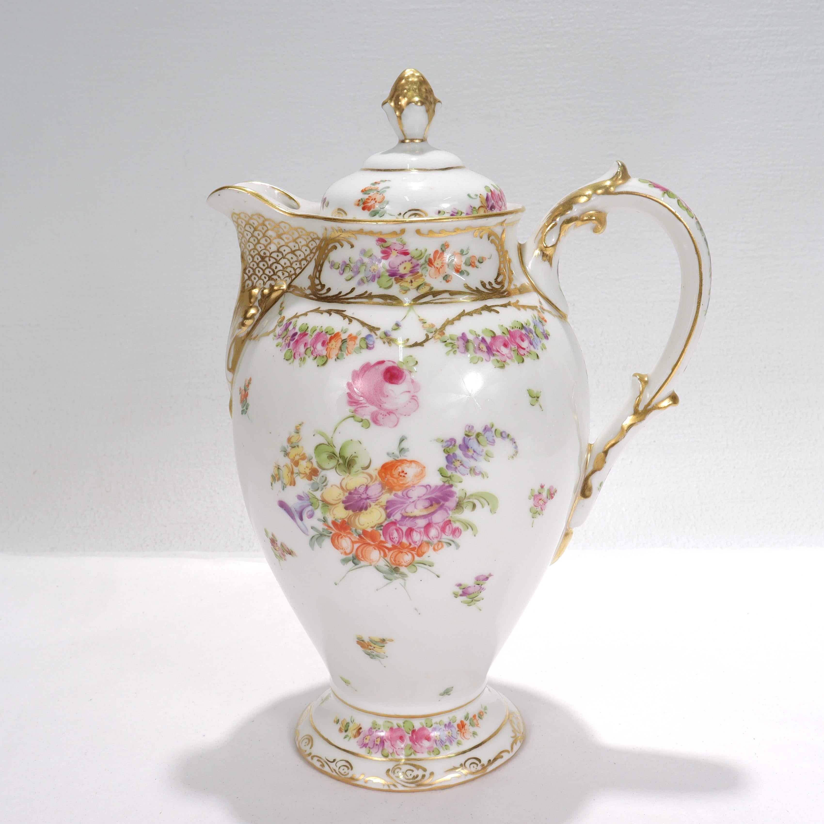 A fine antique Limoges porcelain chocolate or coffee pot.

Made by D&C (Delinieres & Co).

Decorated throughout with rich gilding, floral sprays, and hand painted Dresden type Deutsche Blumen.

There are small black specks or dots to the body