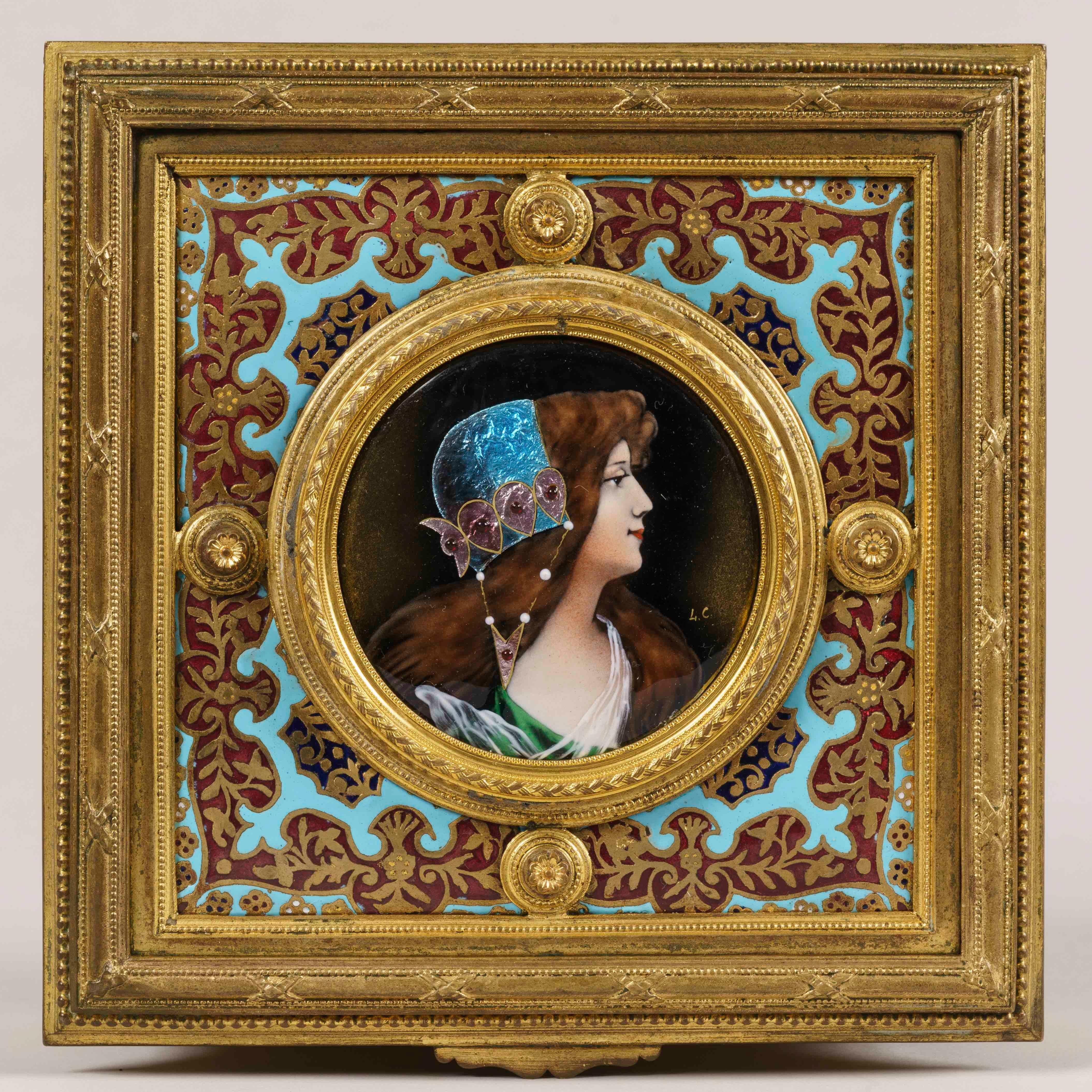 A French jewelry casket

Of square form, constructed in cast and chased bronze, rising on toupie feet; the top and sides having champlevé decoration, and Limoges style enamelled polychrome and iridescent panels of young maids, one initialled 'L.C'