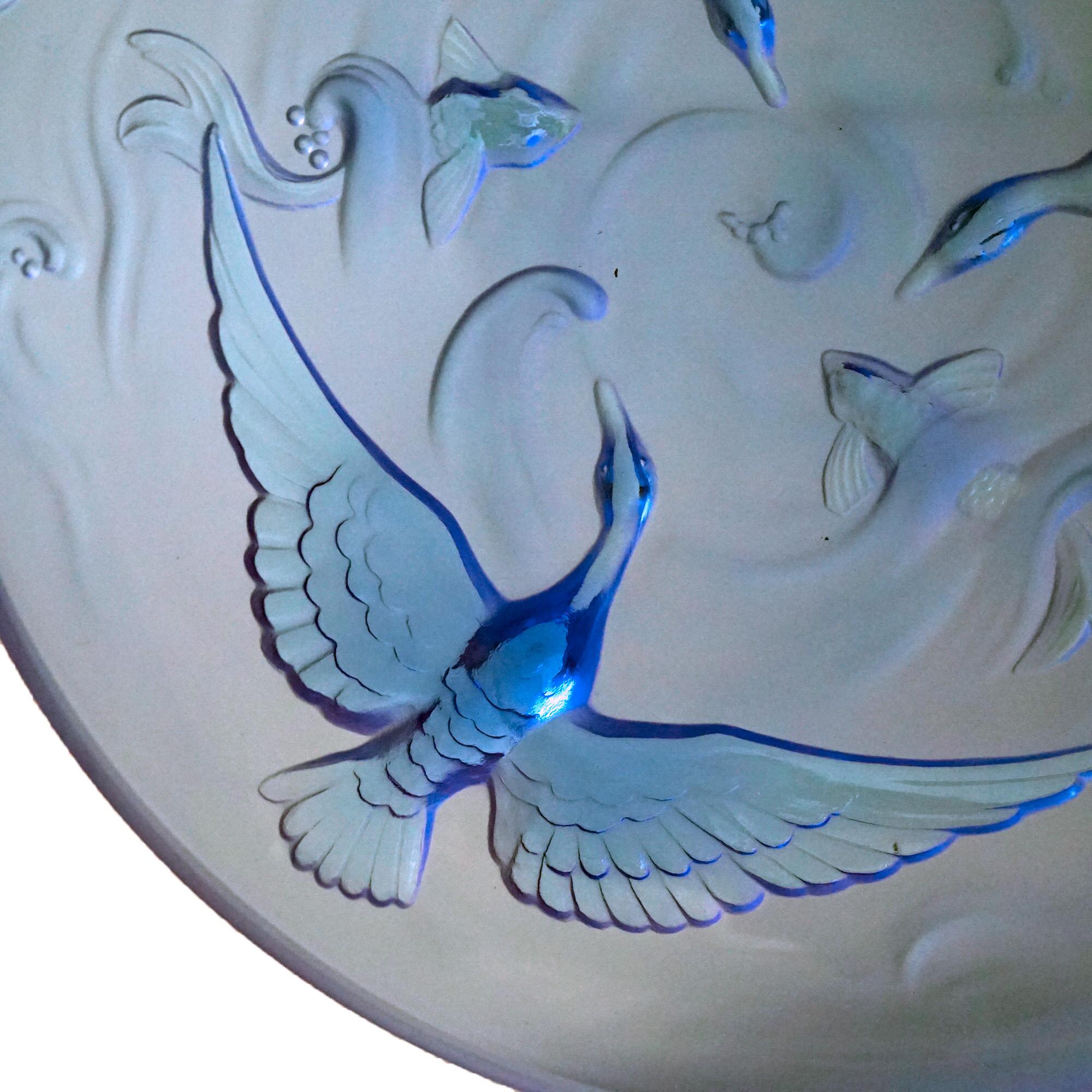 A large antique French Limogés bowl offers celestial blue glass construction embossed with pond scene having cranes or swans flying over koi fish, c1930

Measures- 3''H x 13.5''W x 13.5''D