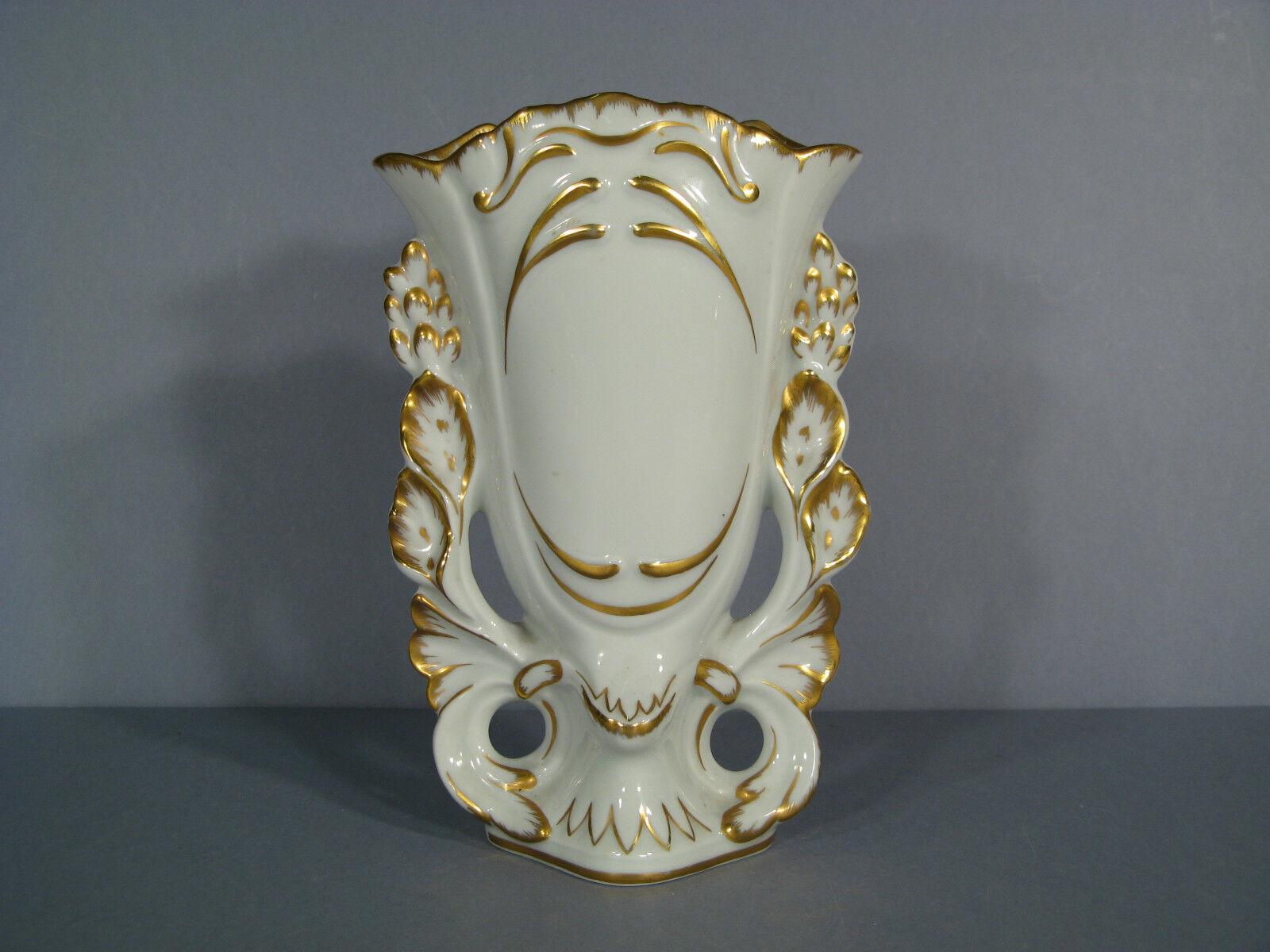 This charming church or bridal vase, crafted from Limoges porcelain, dates back to the first half of the 20th century. It features a hand-painted design with wheat motifs, accented with golden trim. The vase is signed 
