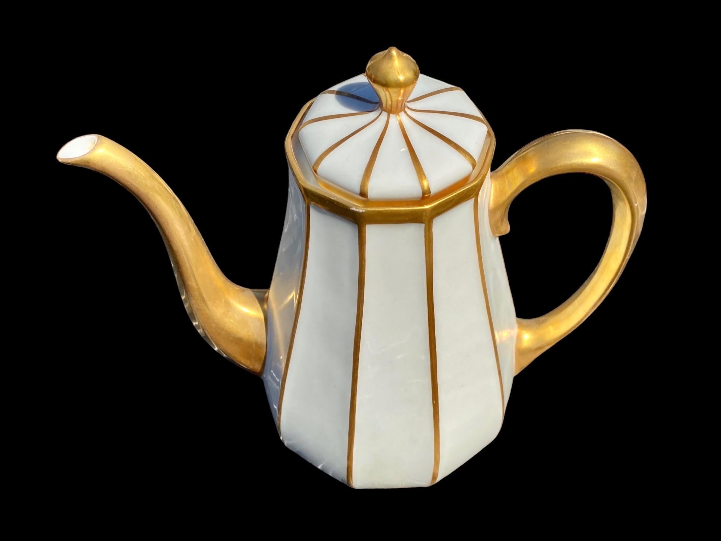 A lovely early 20th century French Limoges coffee pot having 14 karat hand applied gold striped accents, handle, and spout, on a pure white background, in flawless condition.
A piece of history, to behold and cherish today, and for future