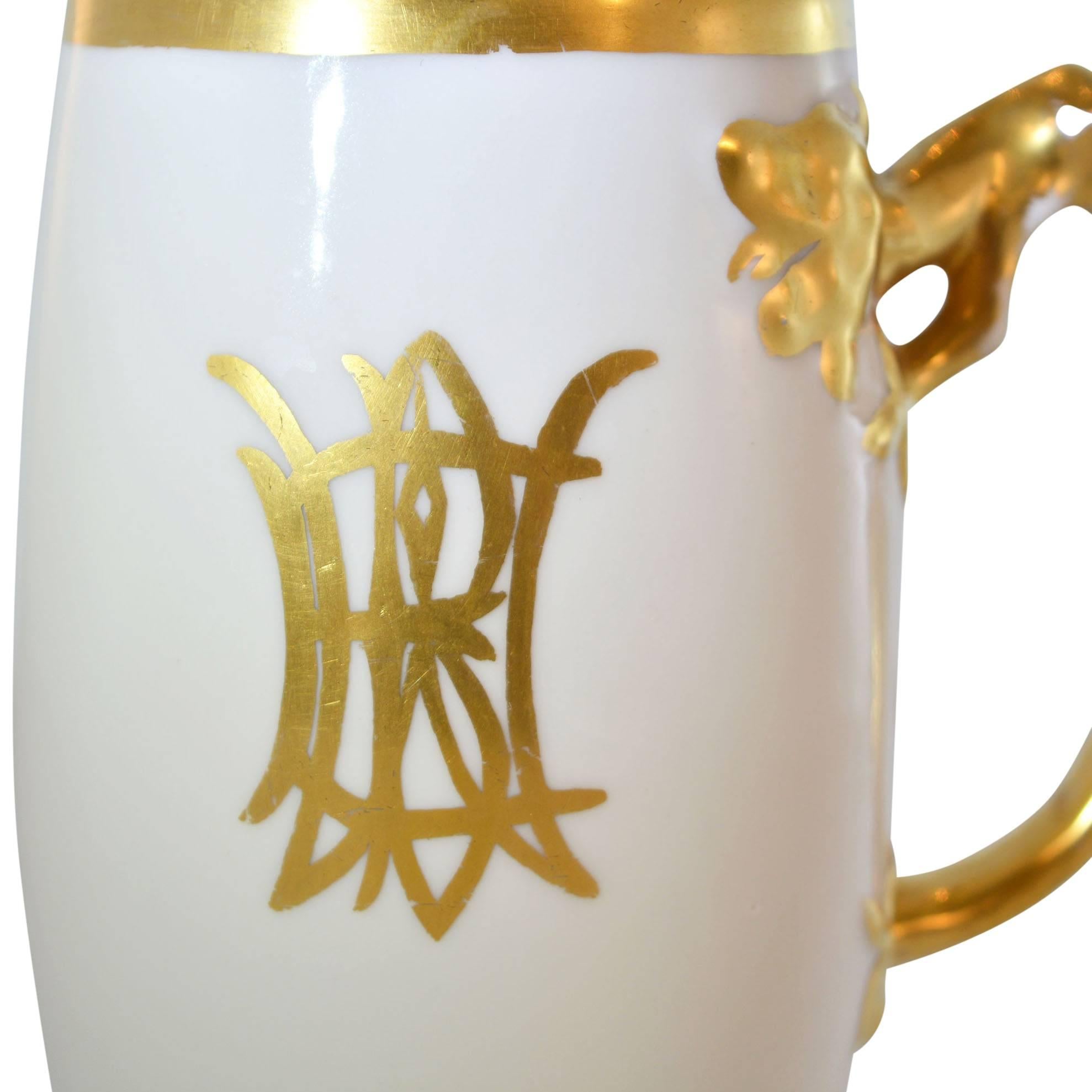 What an interesting stein! We just love the dragon handle - certainly sends a message to anyone thinking about taking your drink. It has a centre monogram on the front and gold rimmed top and bottom. It is marked on the bottom with M.E.B. 1912 in