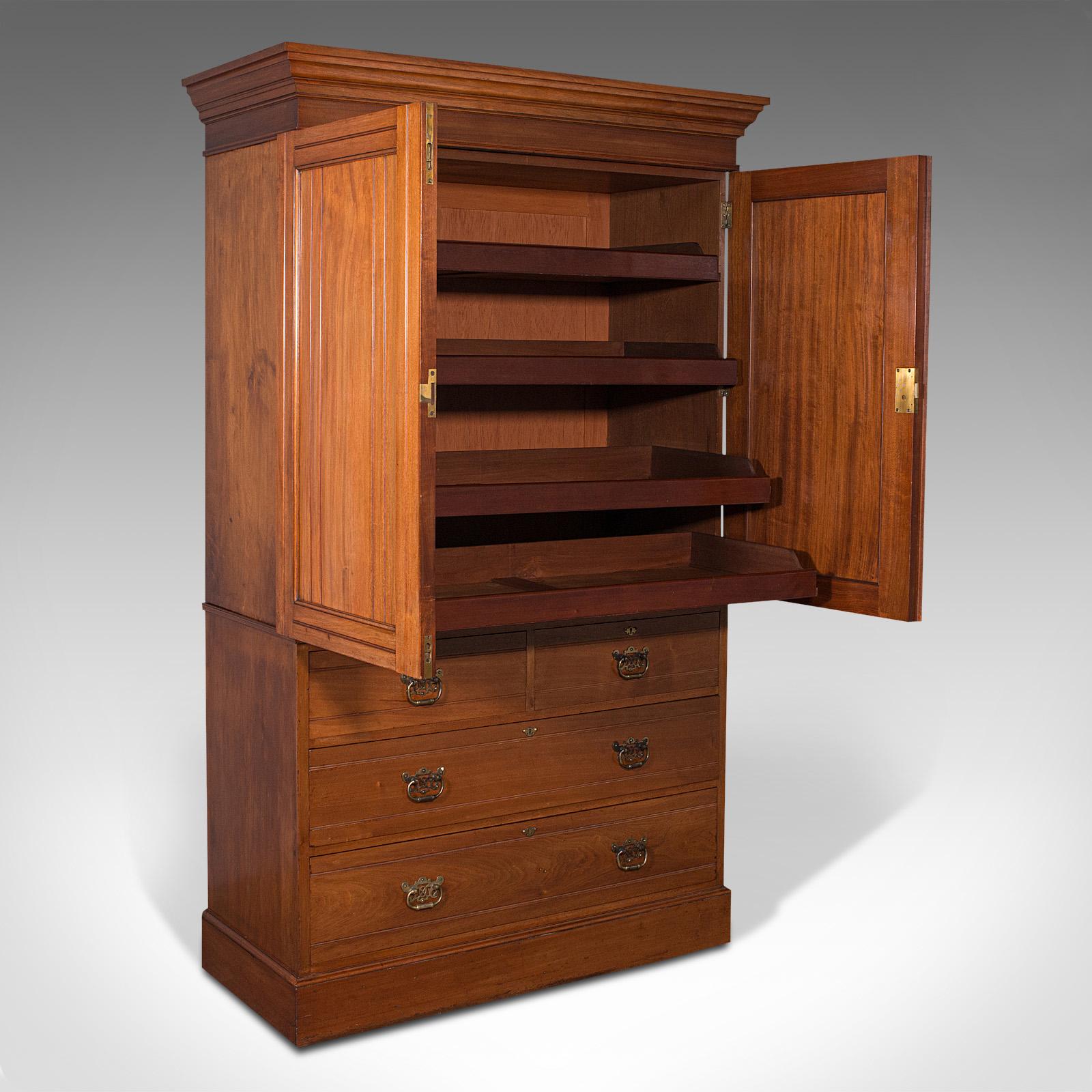 This is a quality antique linen press cupboard. An English, walnut gentleman's cabinet by Hewetson & Milner of London, dating to the Victorian period, circa 1890.

A cabinet of the first order, with imperious craftsmanship throughout
Displays a