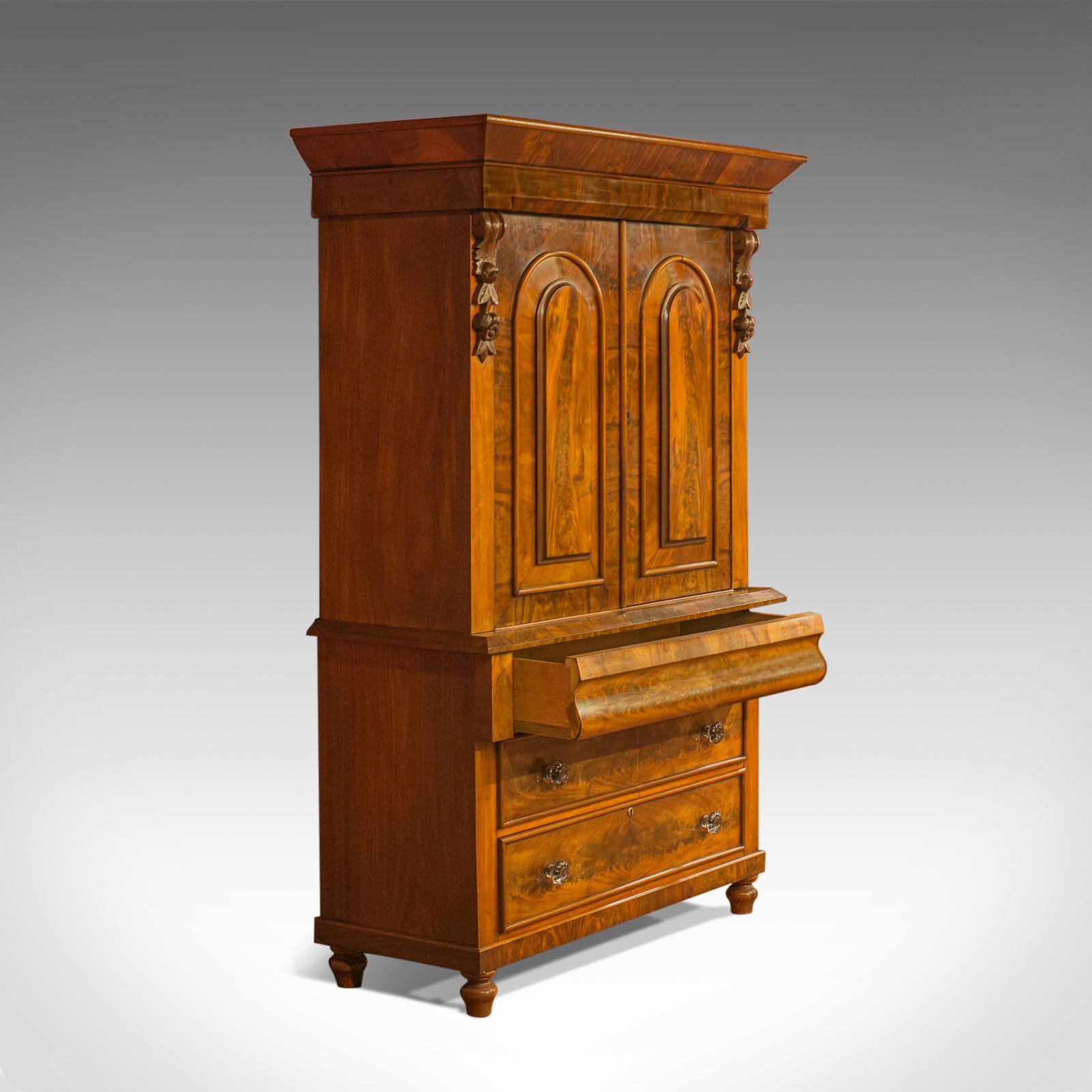 This is an antique linen press, an early Victorian, housekeeper's cupboard in flame mahogany dating to mid-19th century, circa 1860.

A fine example in select flame mahogany
Displaying grain interest in mellow, russet hues 
Desirable aged patina