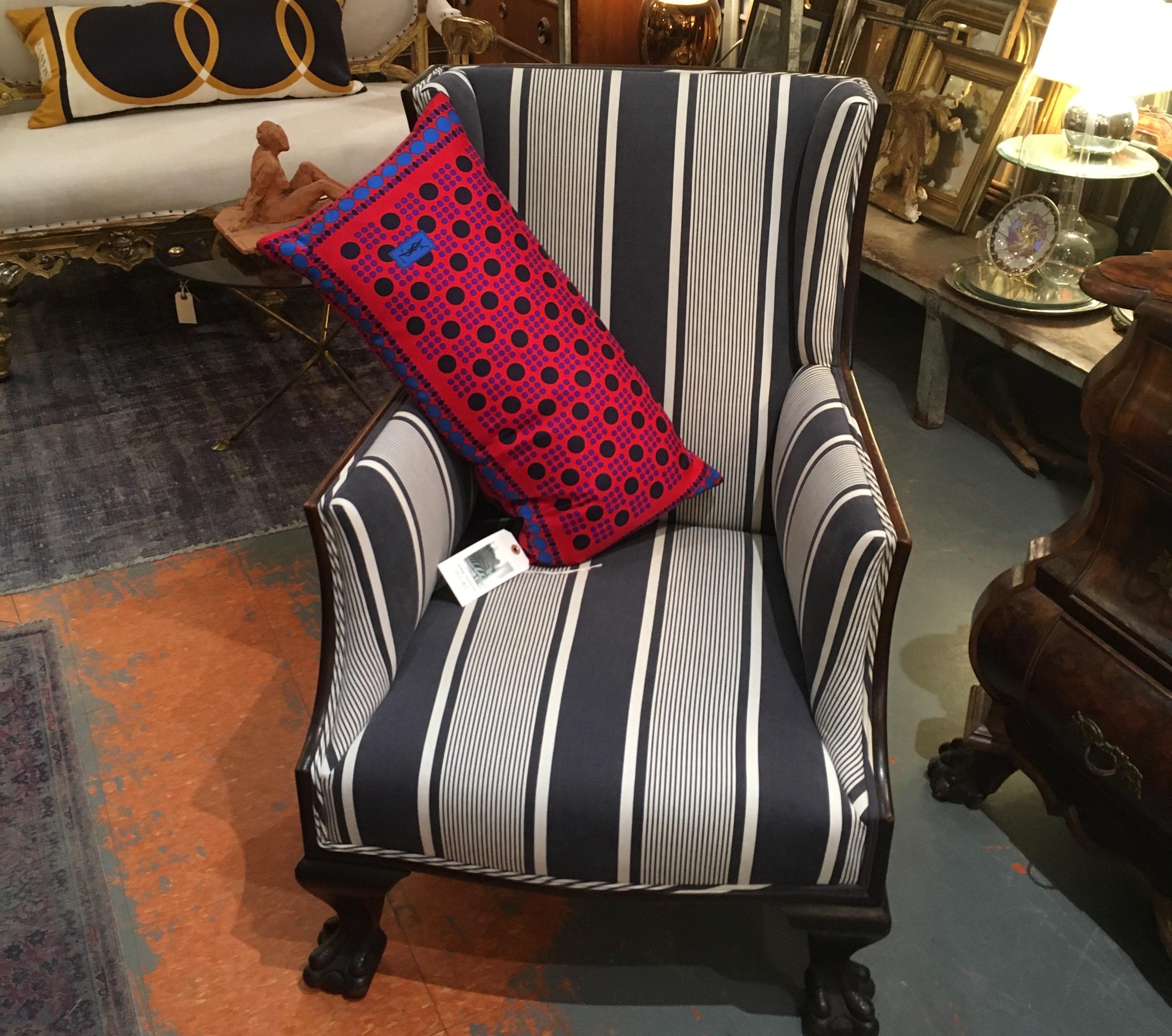 Antique English chair with stately hand carved wood lion paw feet. Newly professionally reupholstered in crisp antique blue and white stripe fabric from France.