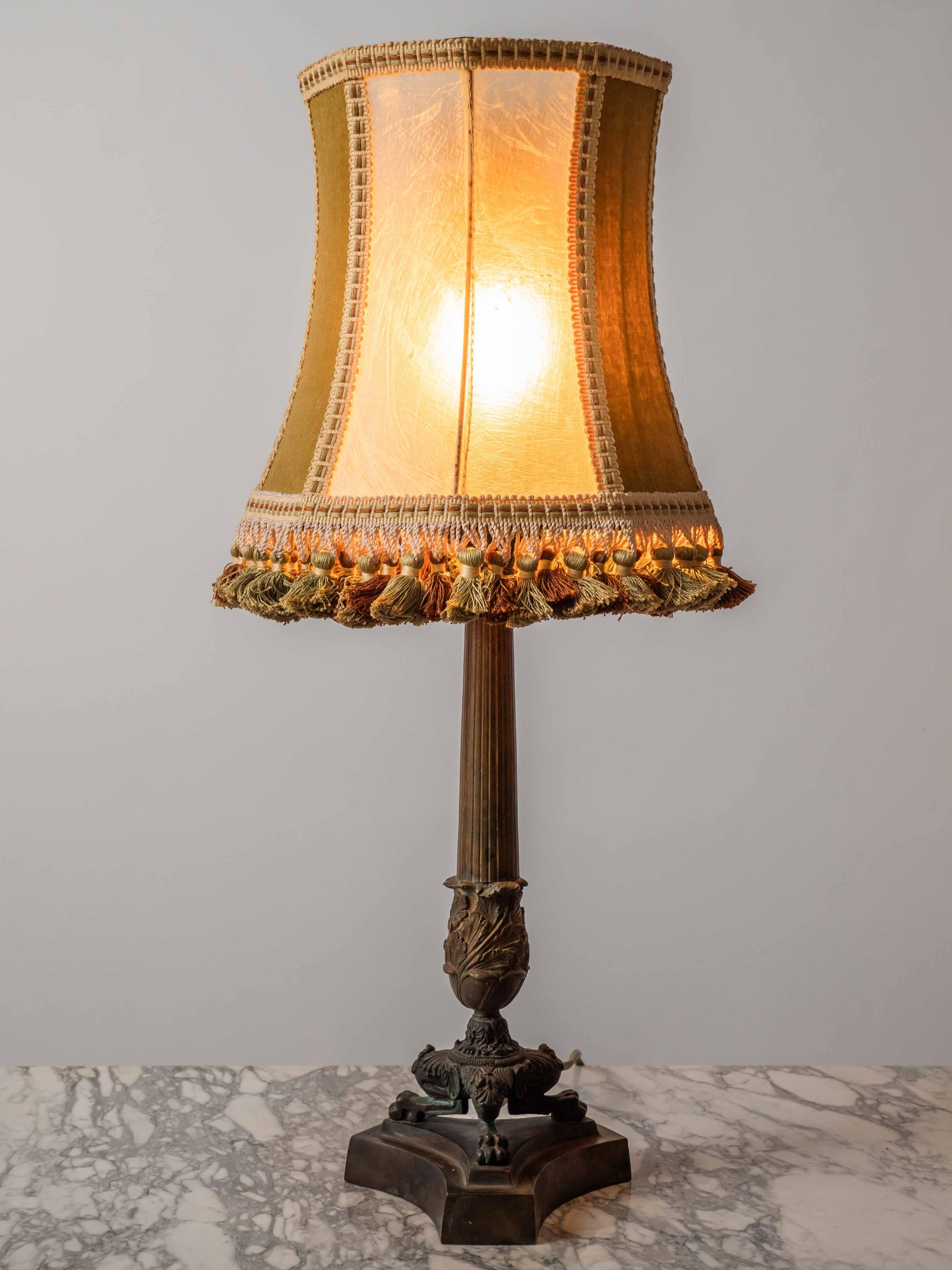 Antique lion paw lamp

The table lamp is made of brass on a wooden base with a shade made of beef bladder combined with fine mohair fabric. The lamp has a beautiful distinct patina. The shade is decorated with a decorative gate and tassels in the