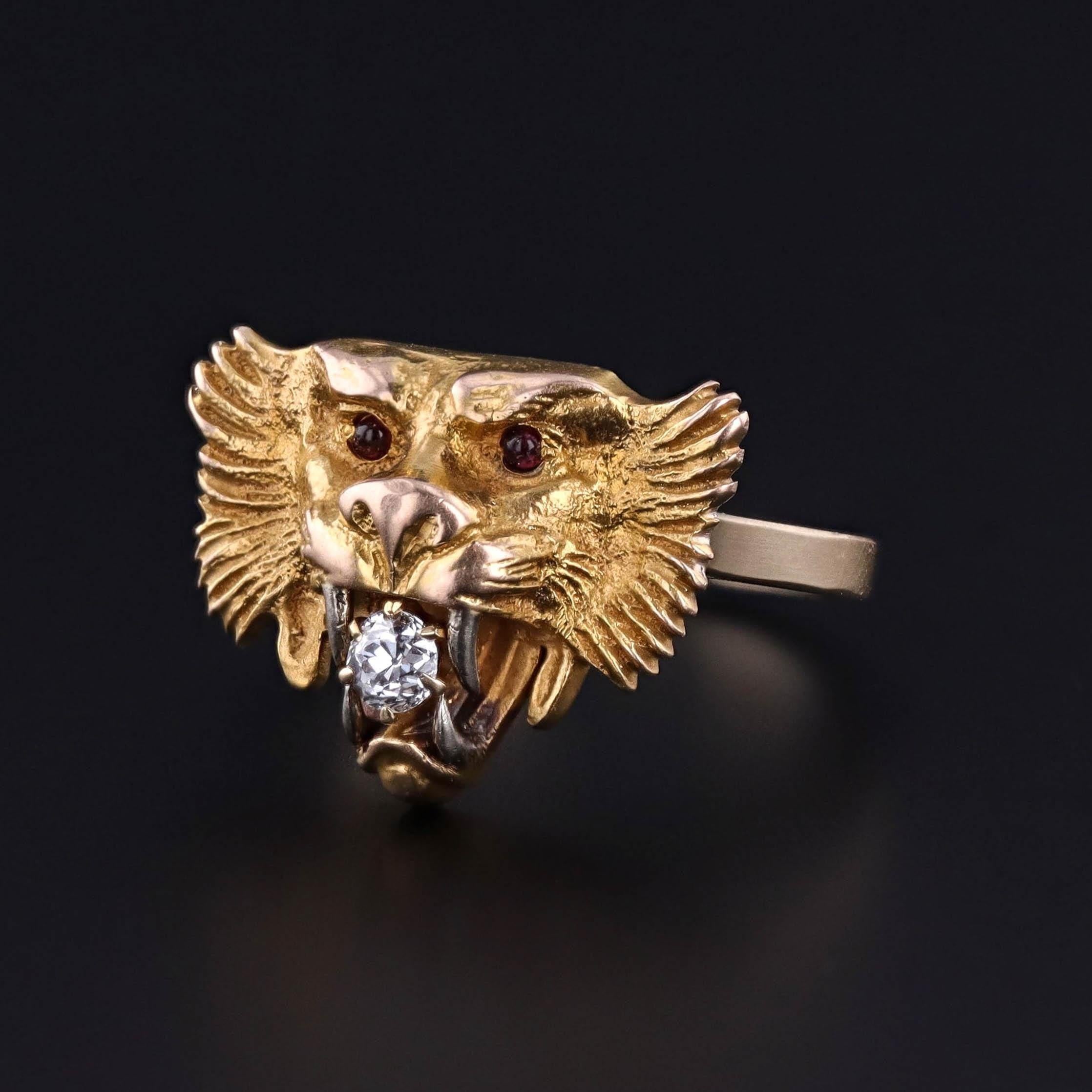 Antique Lion Ring: This ring features a lion of 14k gold with a diamond in its jaws and two red paste eyes. It was originally an antique stickpin (circa 1910) that our jeweler transformed by removing the pin and adding a 14k gold band.

The face of