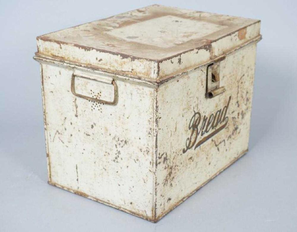 Antique lithographed tin storage box for bread or bake goods. Top opening, having handles and pierced holes on either side. Measures: 10.5 inches x 13.5 inches x 9.5 inches.