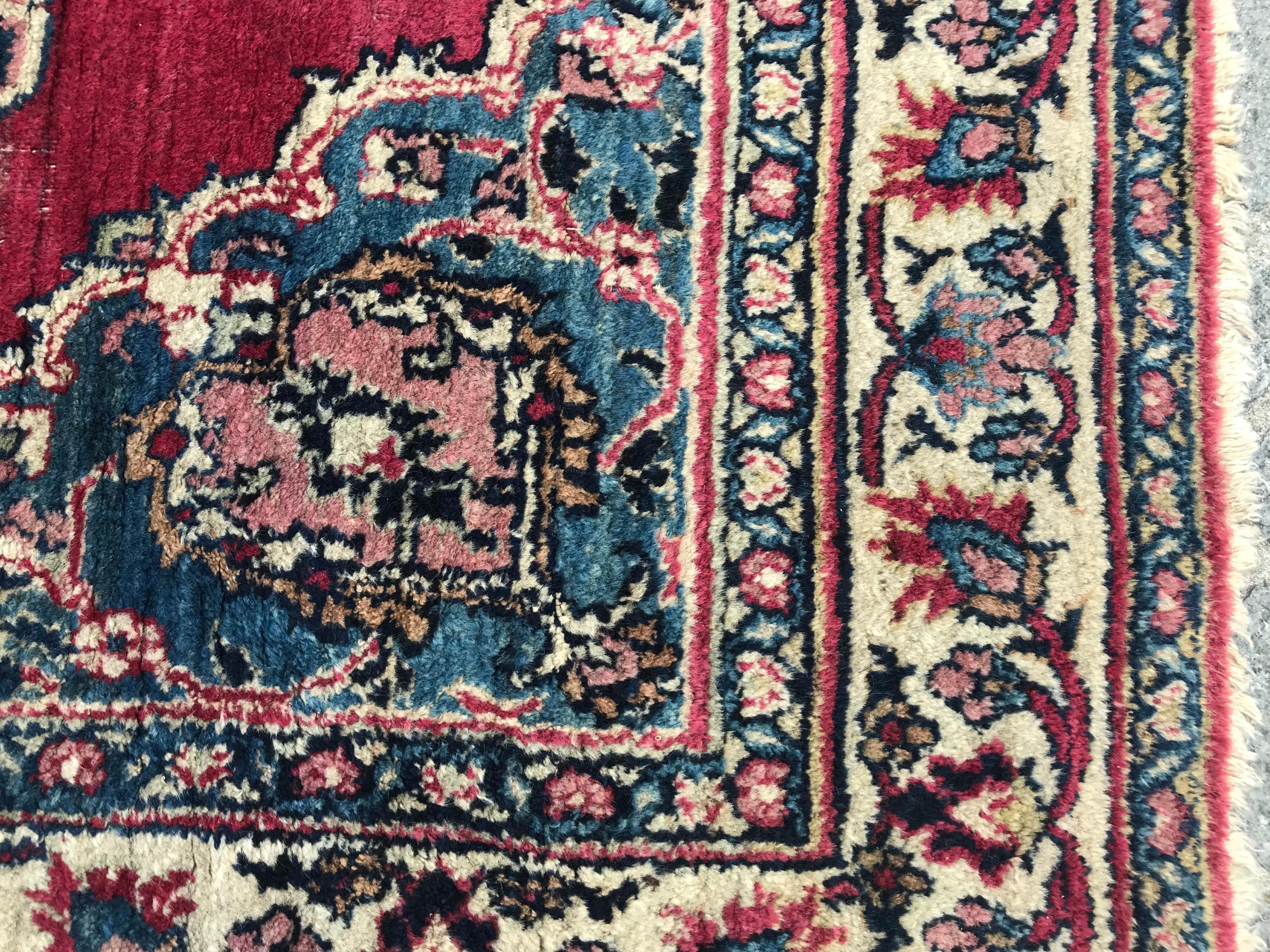Beautiful late 19th century rug with a central medallion design and beautiful natural colors with blue, red and pink, entirely hand knotted with wool velvet on cotton foundation.