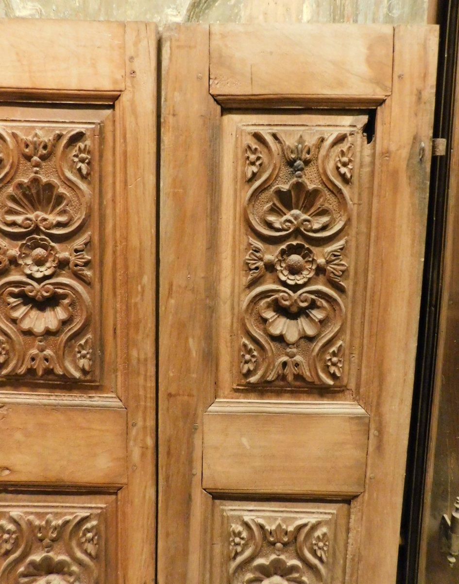 Ancient pair of small panels or doors, richly carved in the panels, handmade in precious light walnut, from Italy, produced entirely by hand in the 18th century, suitable for wardrobes, small furniture or cabinets, masonry kitchens or as decorative